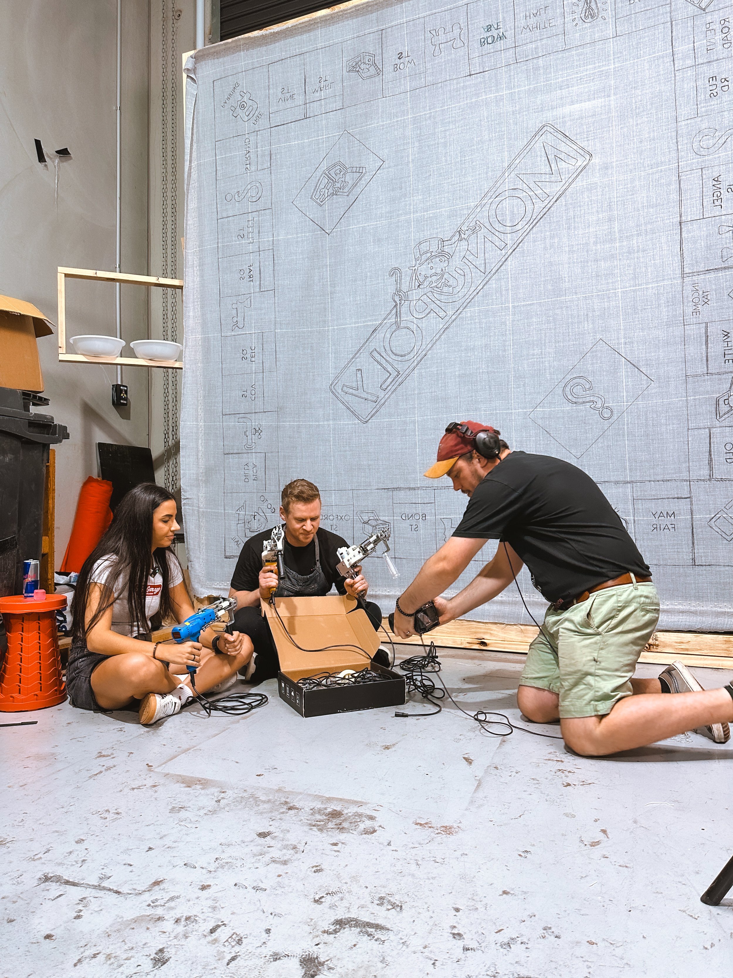Three people working filming behind the scenes of the Jazza x Chrystal Youtube collaboration video.