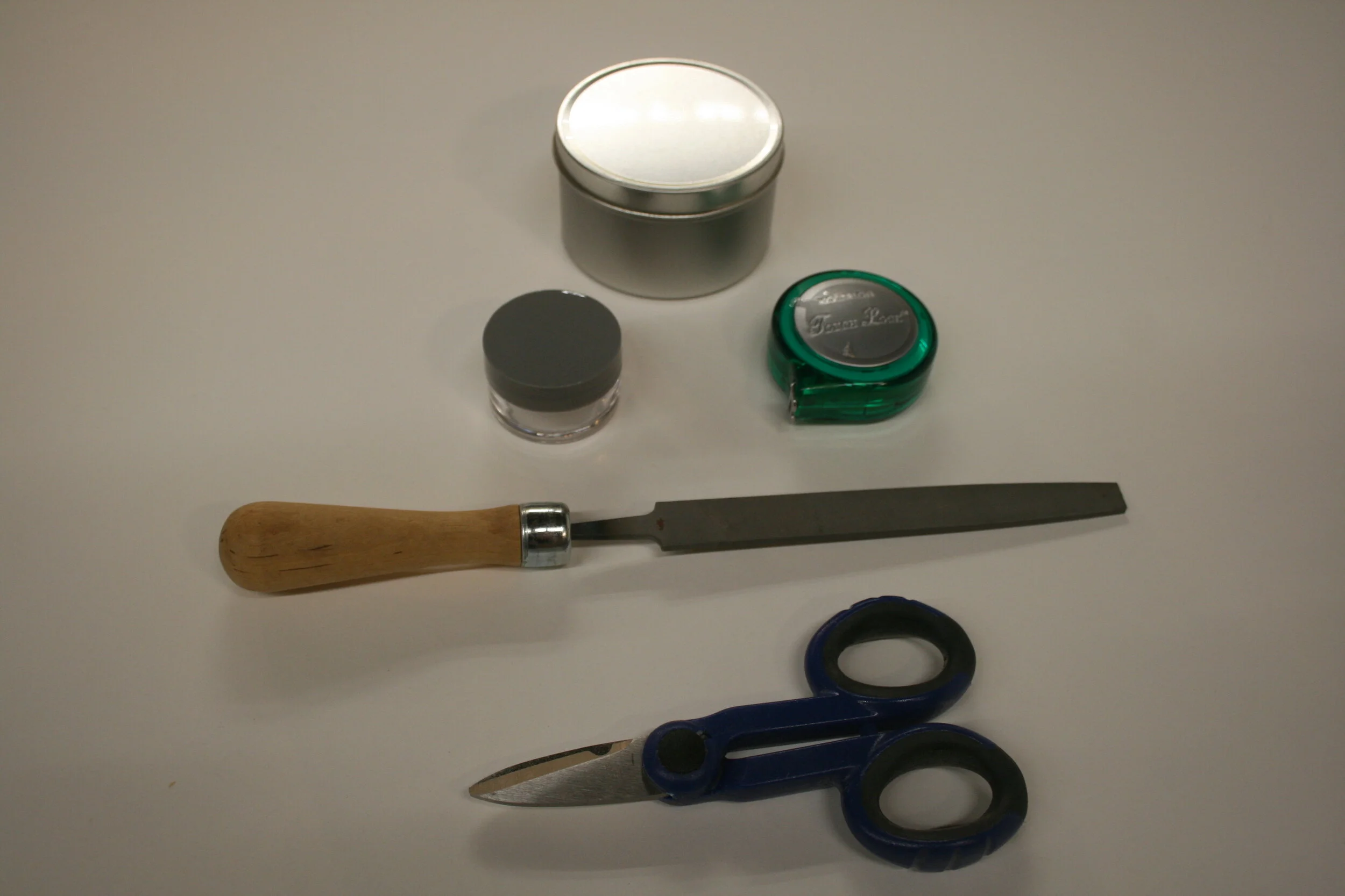 Jar for root starter, measuring tape, short pruning scissors, sharpening file, assortment of glass jars for cuttings