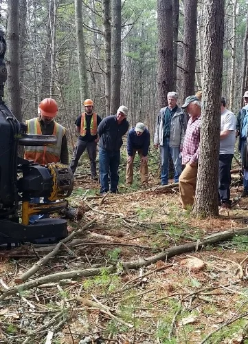 Folks joined KELT staff to learn about the cut-to-length harvester used during the sustainable timber harvest.