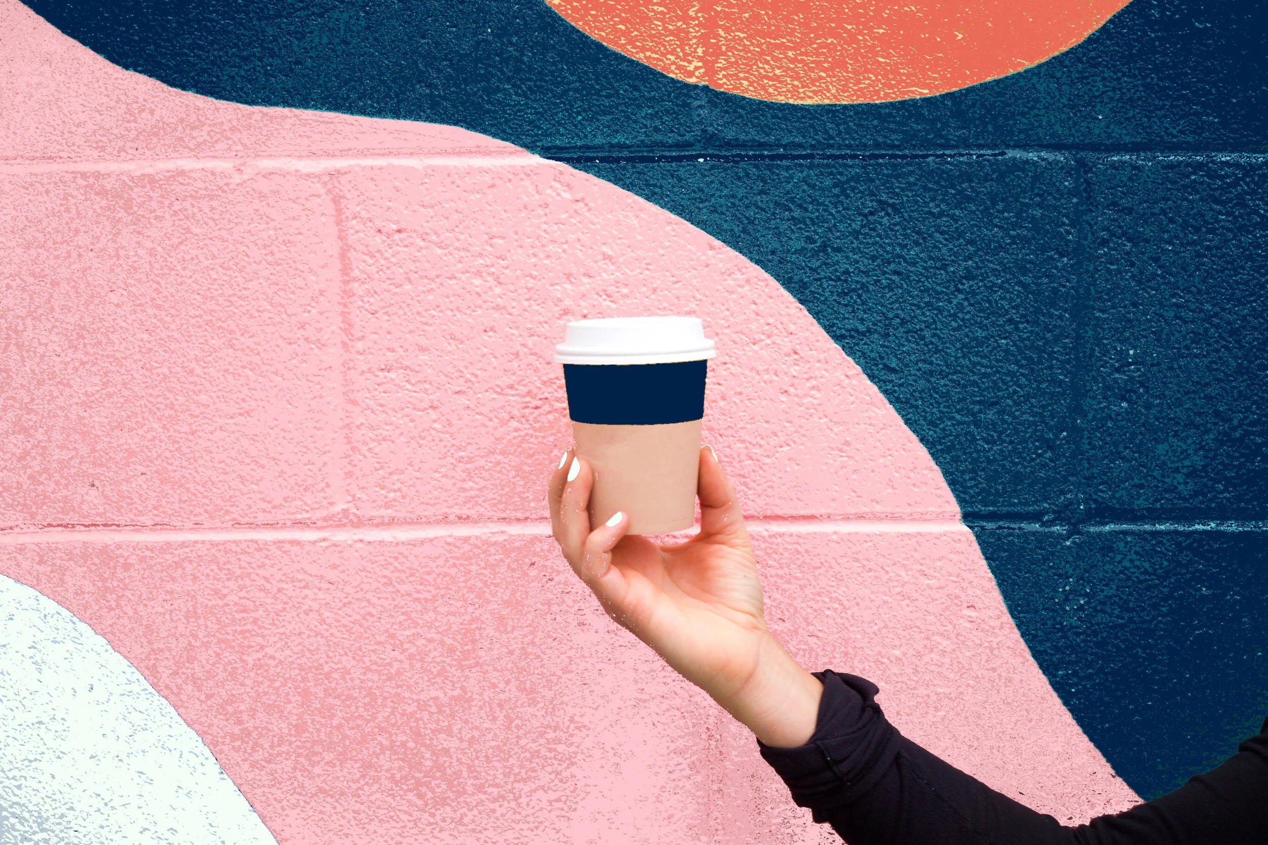 A photo of a coffee cup in a woman’s hand