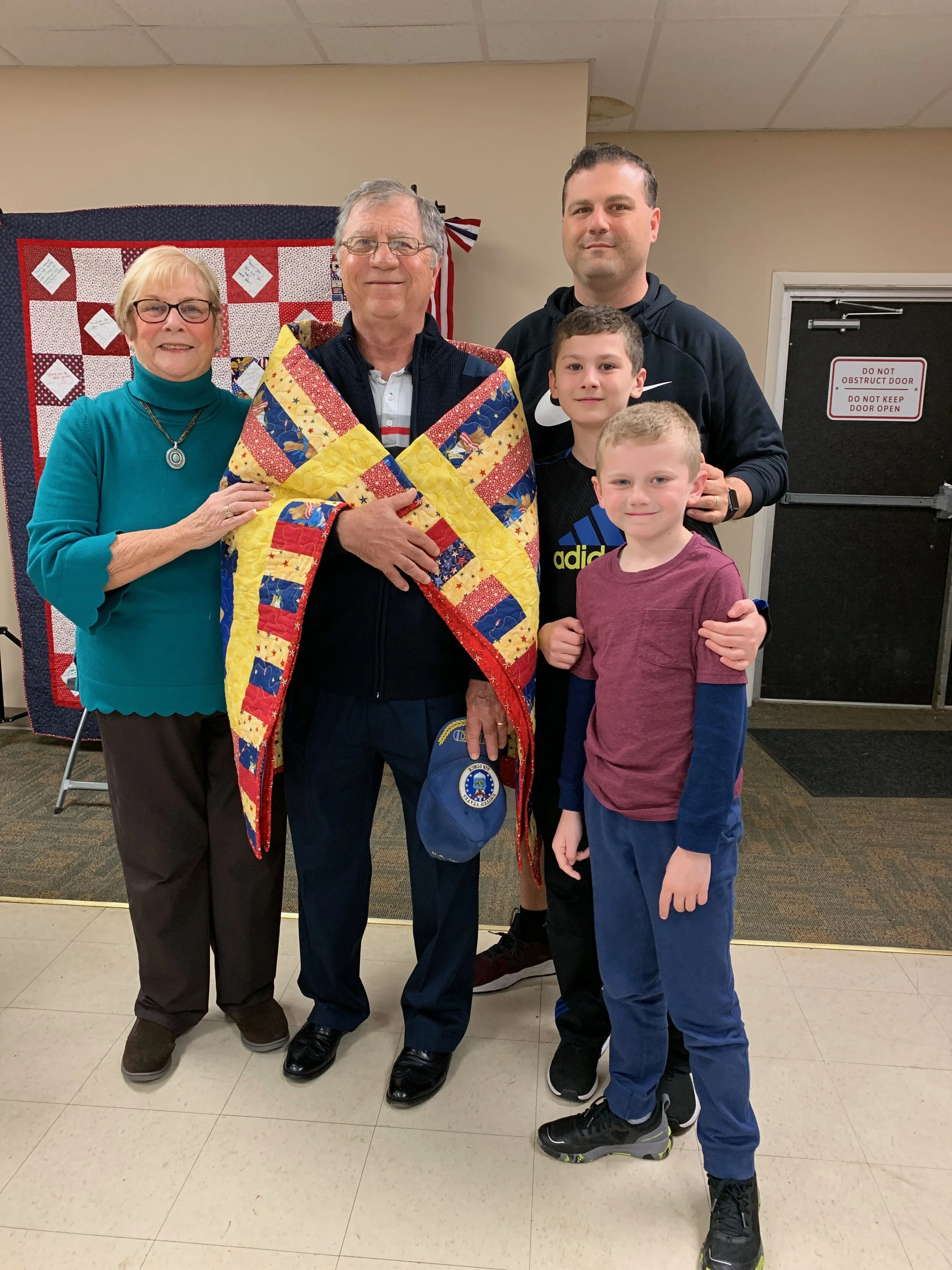 Joan Coley DeGregory’s husband, Jack, receiving his handmade quilt from the Quilts of Valor.