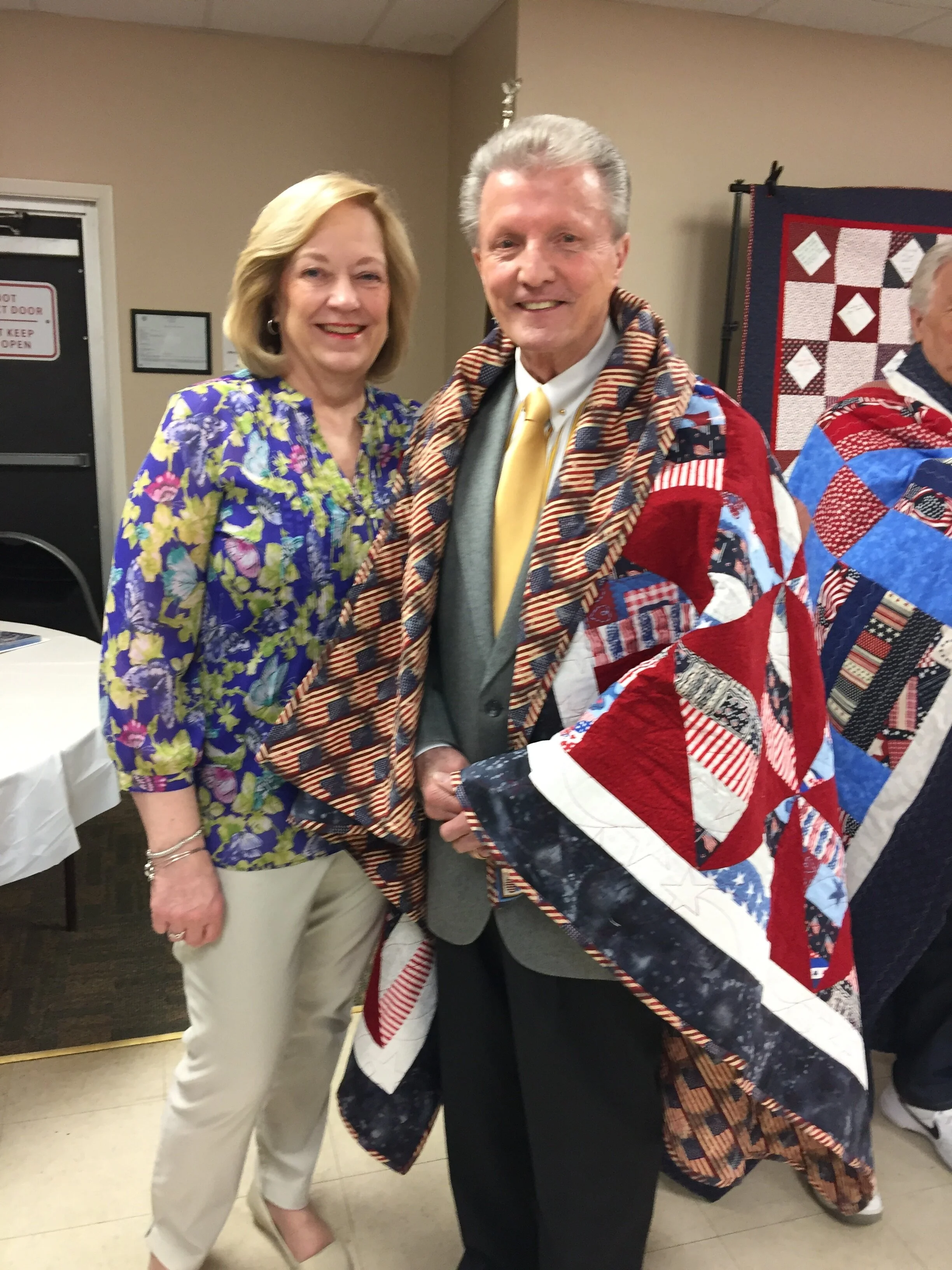 Sharon Ferry Long’s husband, Bob, receiving his handmade quilt from the Quilts of Valor.