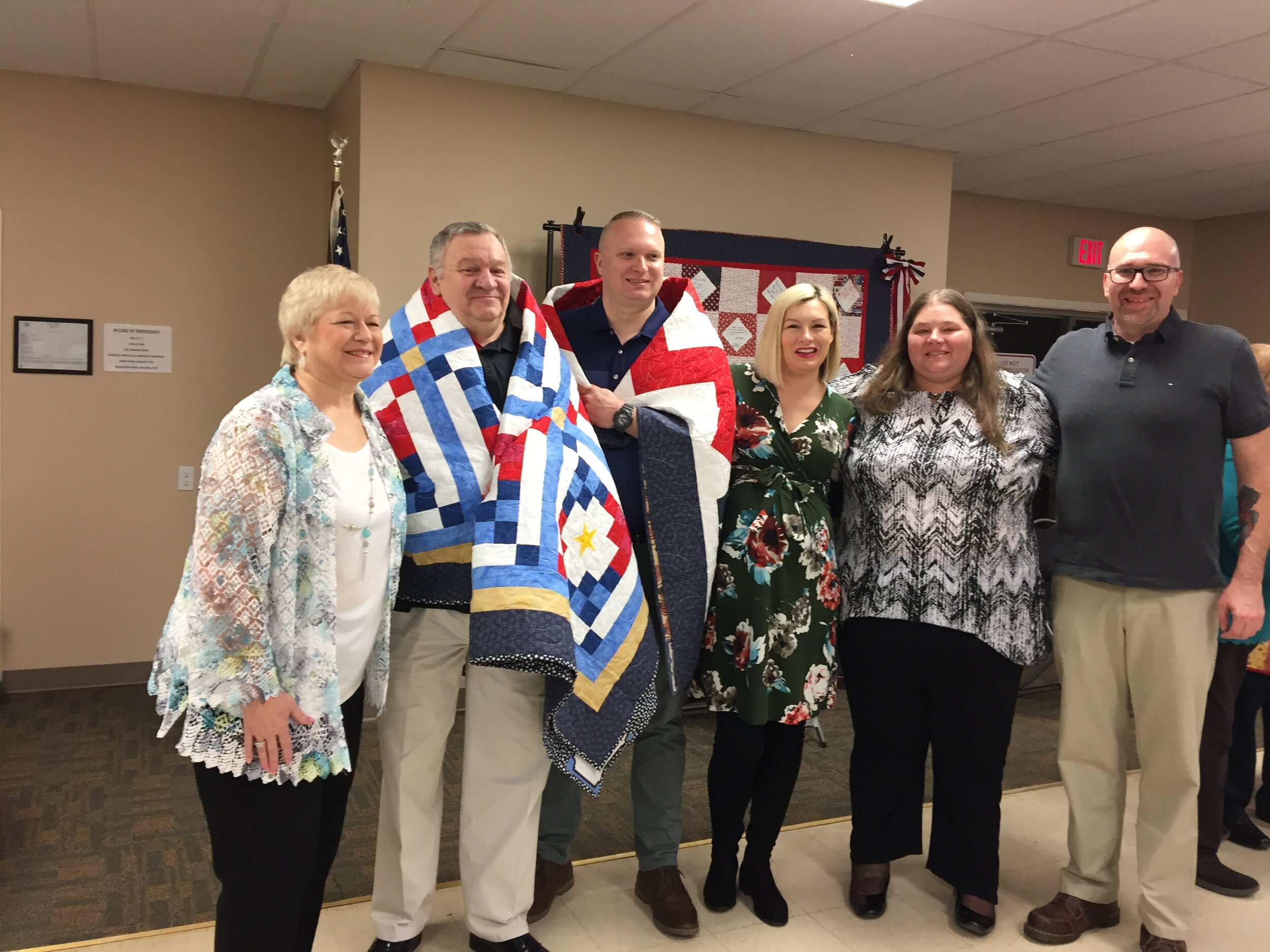 Michelle Thompson Sexton’s husband, Bill, and son, Shaun, receiving their handmade quilts from the Quilts of Valor.