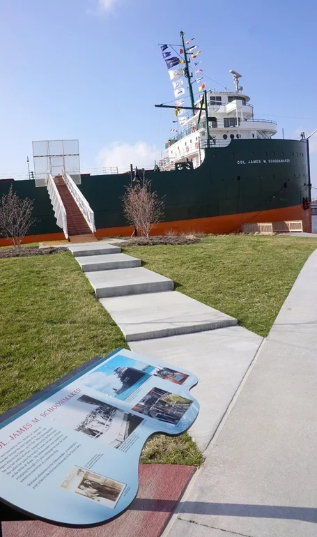 The museum exterior features several exhibits and interpretative panels, including this large ship!