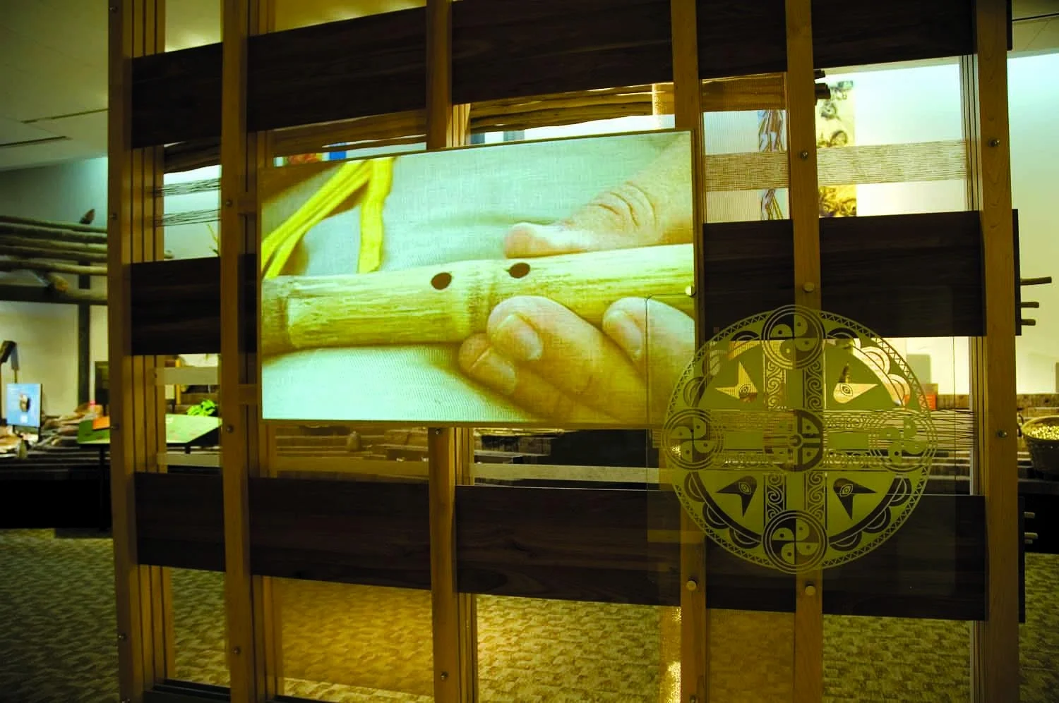 A projection shows a Spirit Lesson, the production of cultural artifacts.