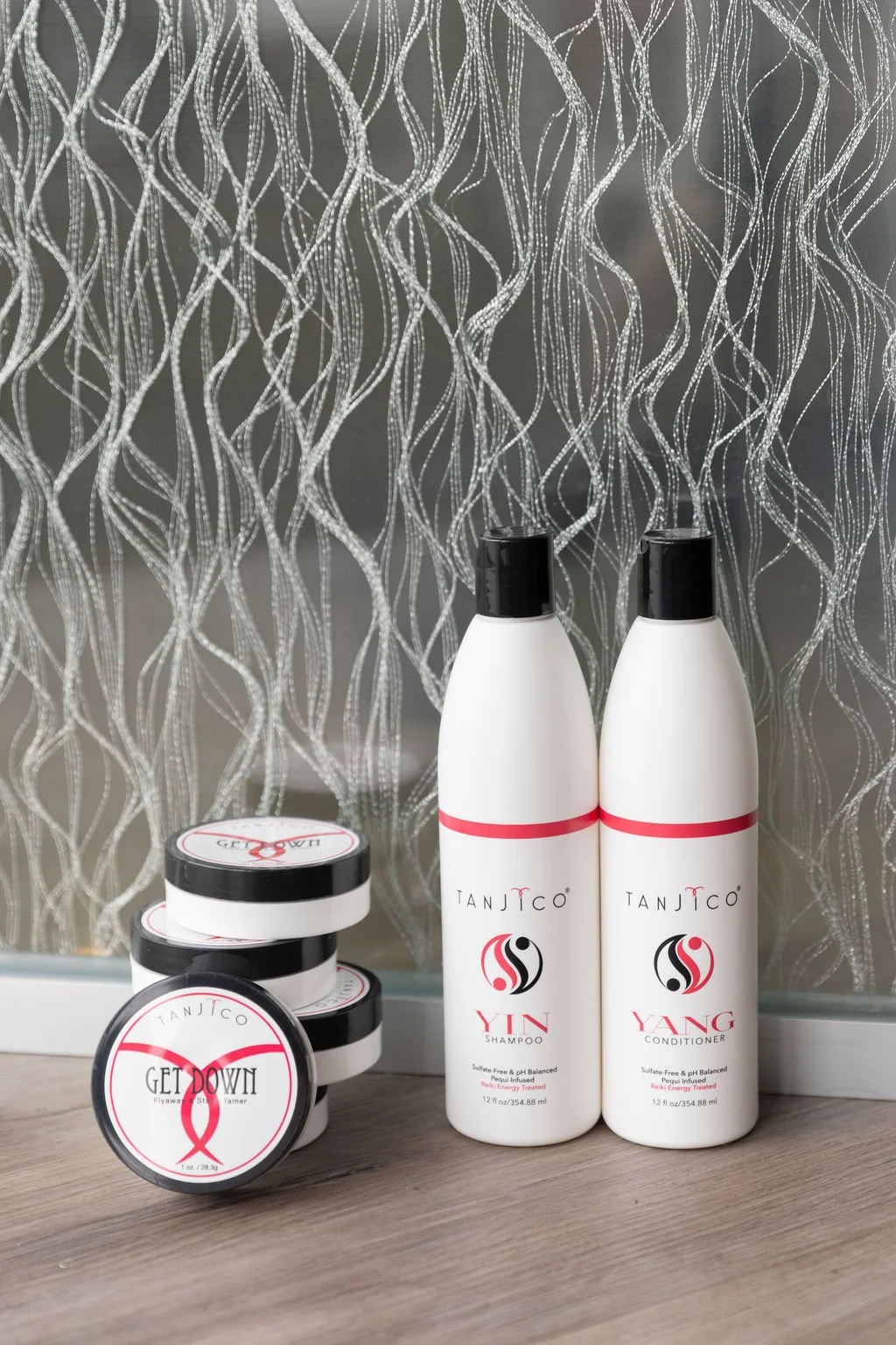 Tanjico products which are shampoo, conditioner, and a flyaway tamer