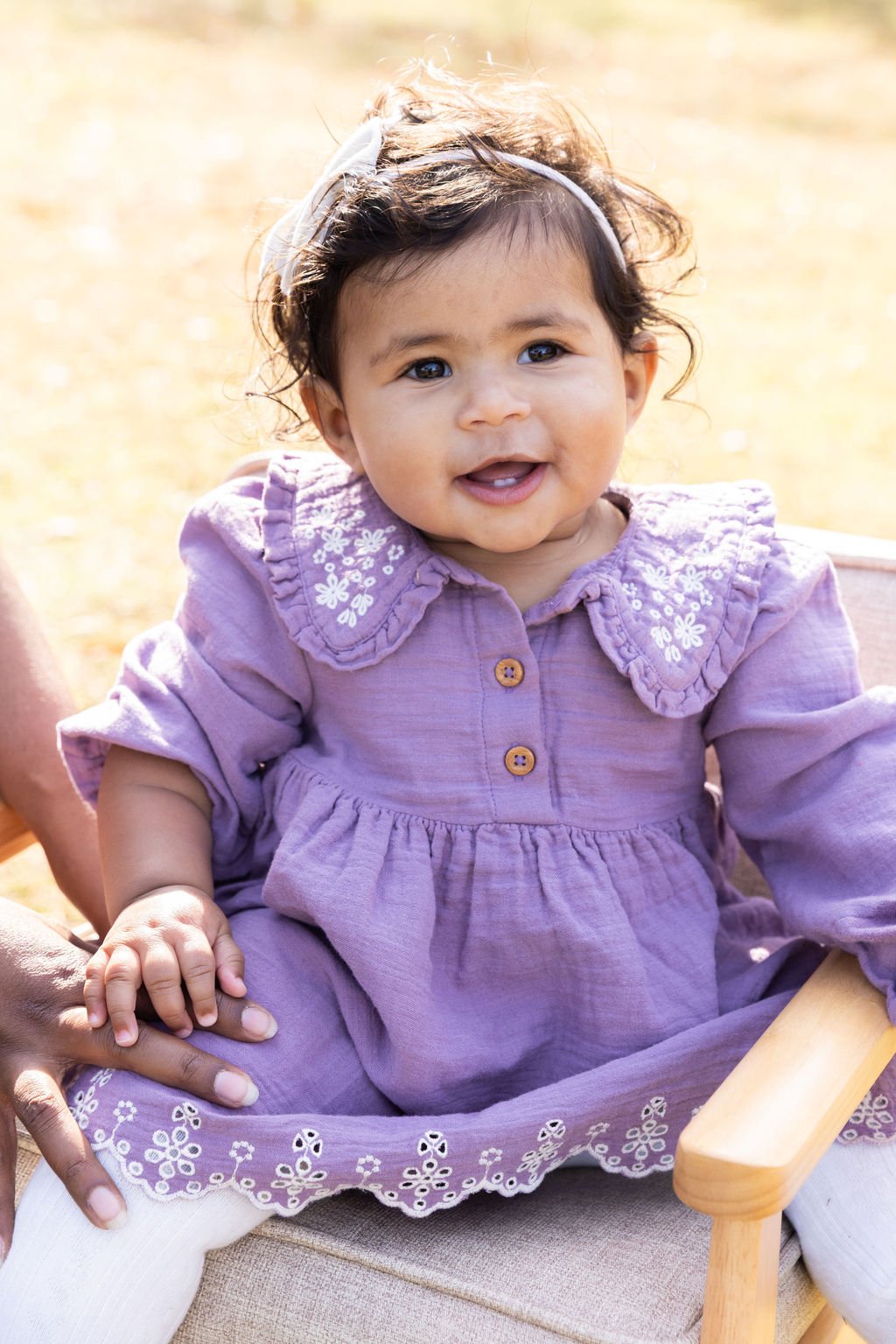 toddler siting on a chair at islip grange park in Sayville, ny