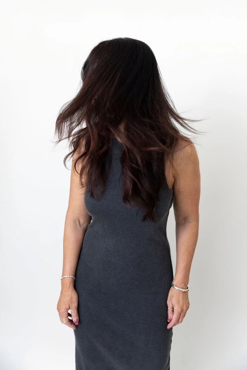 woman shaking her head with her hair over her face for a creative branding photo