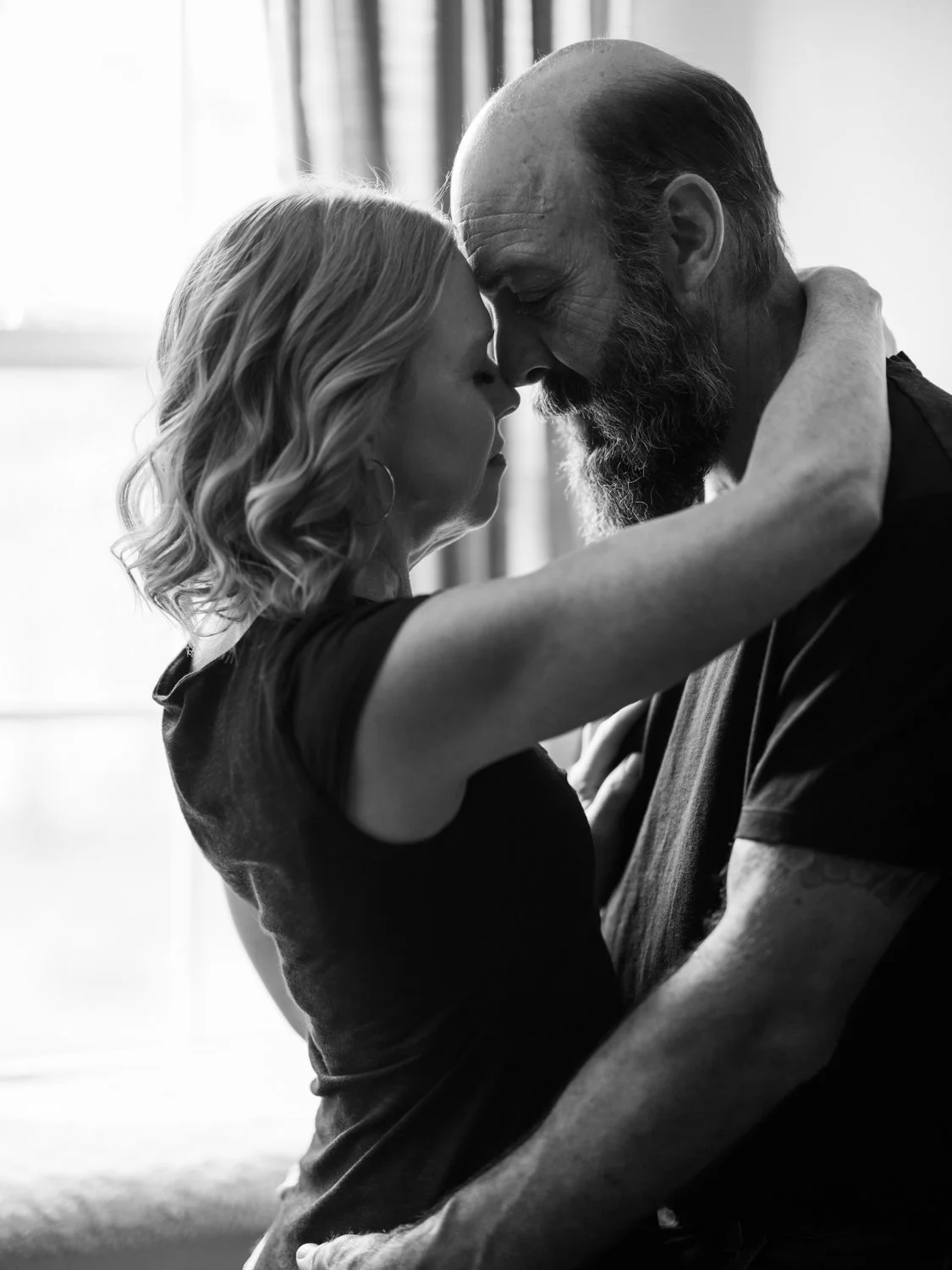 Intimate Couple Embracing During In-Home Erotic Photoshoot