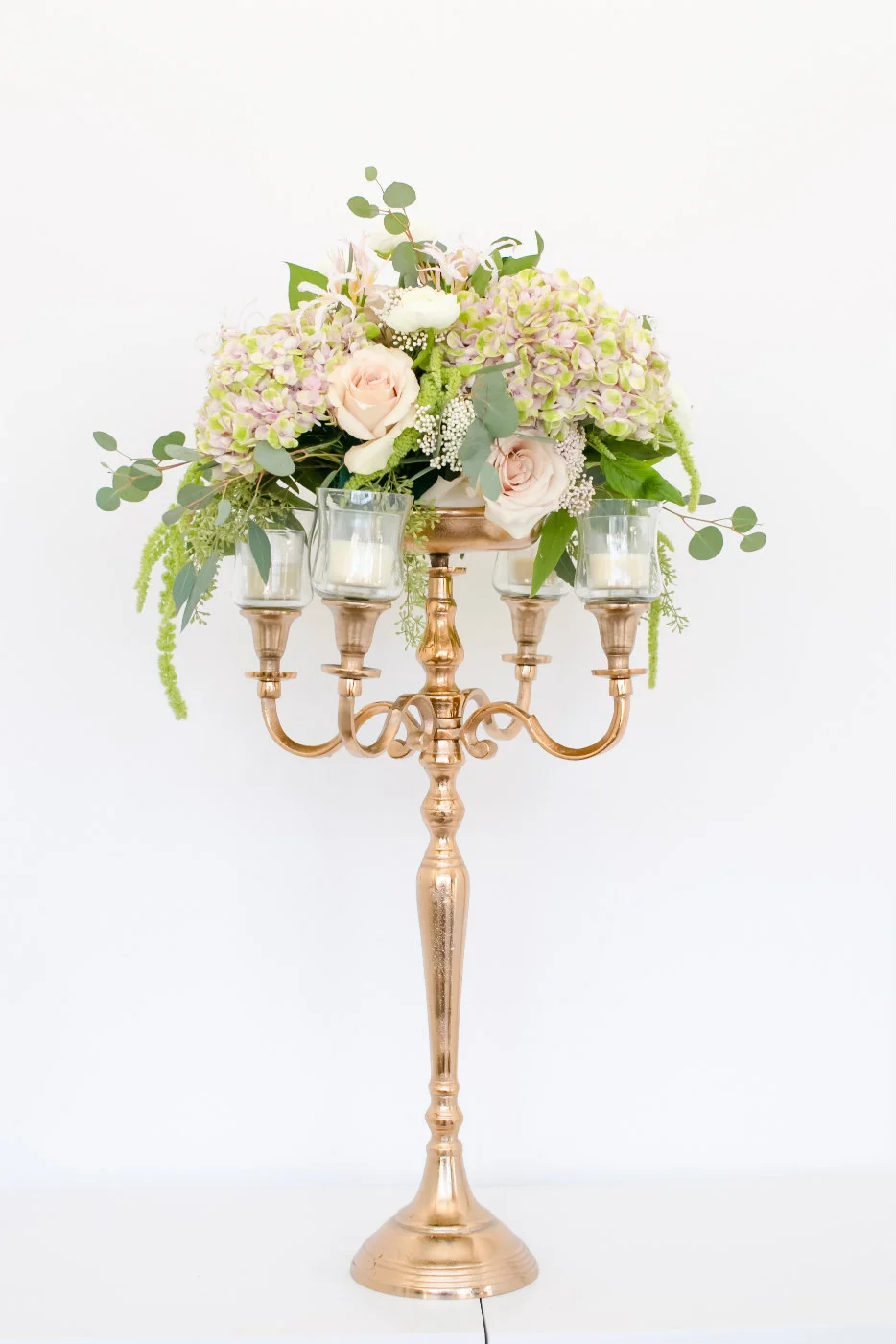 gold candleabra with floral arrangement