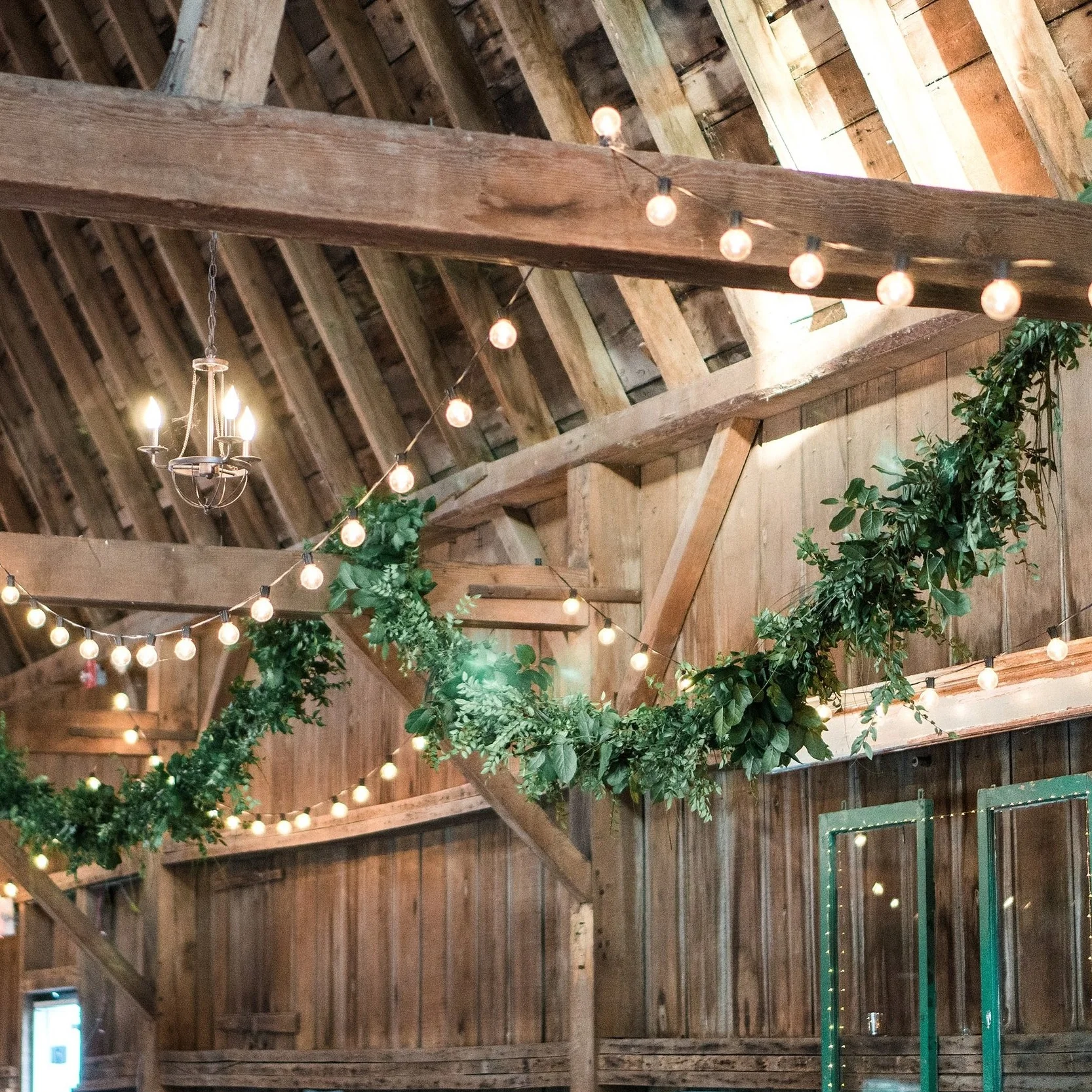 garland and cafe lights hung from barn beams
