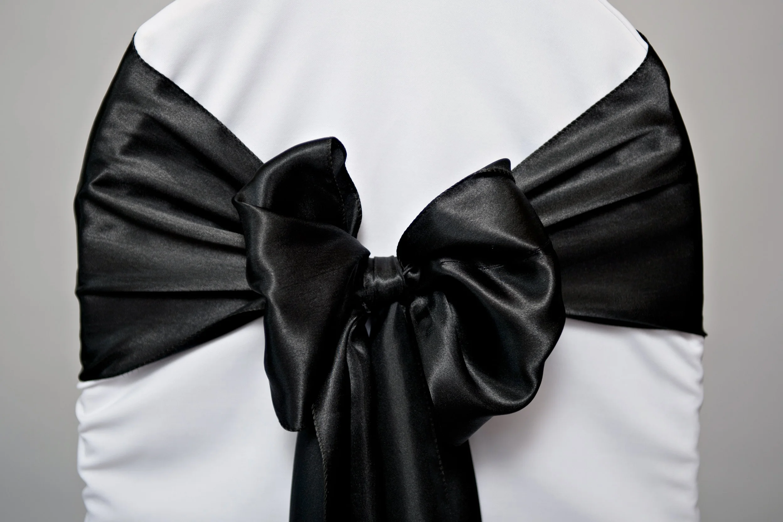 black satin chair sash tied in bow