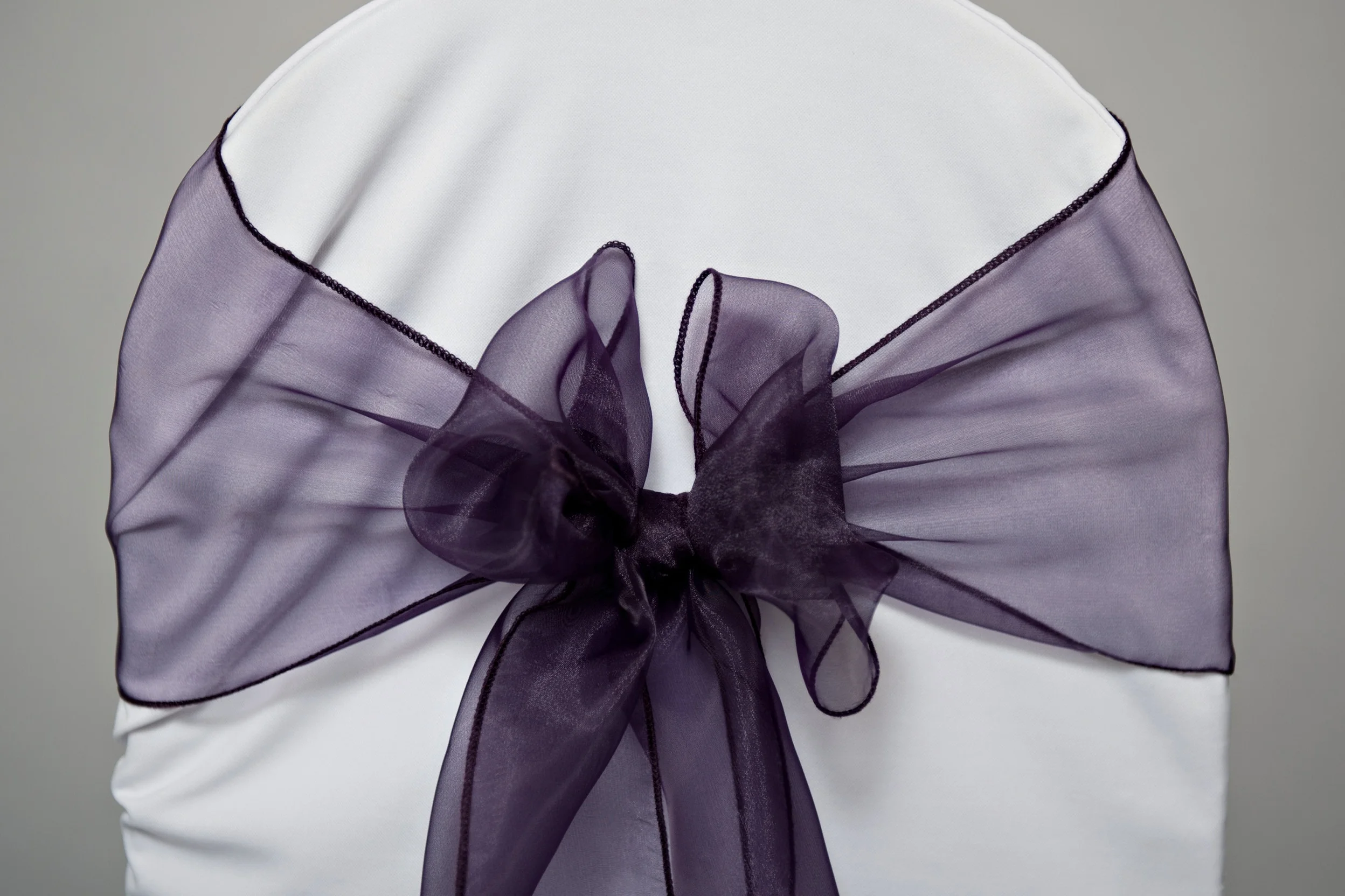 single eggplant organza chair sash tied in a bow