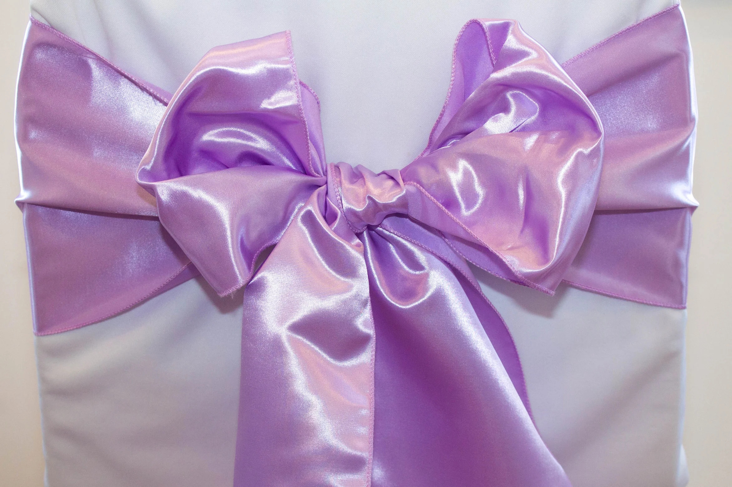 Lavender satin sash tied in a bow