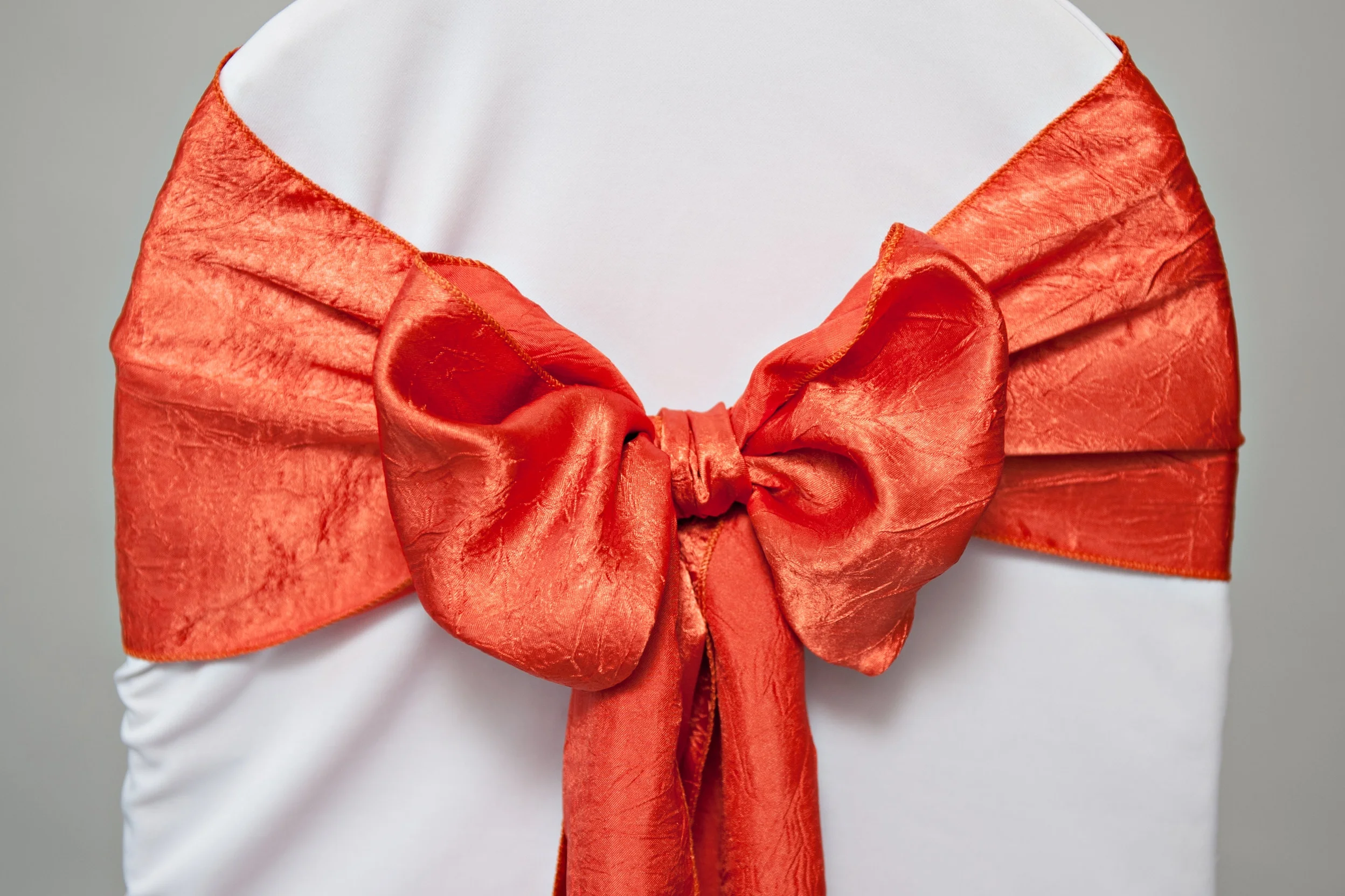 orange luster chair sash tied in a bow