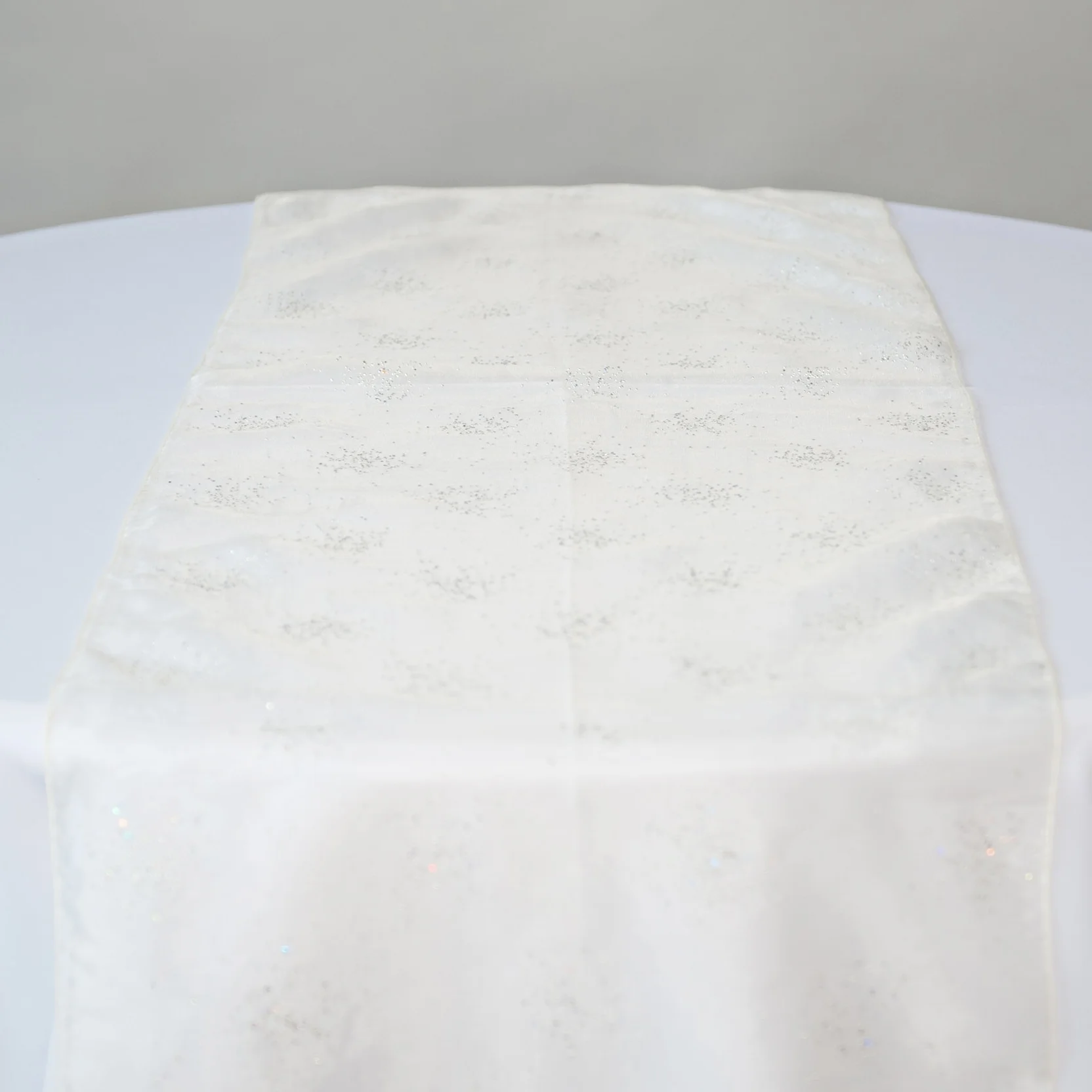 ivory diamond organza table runner on table