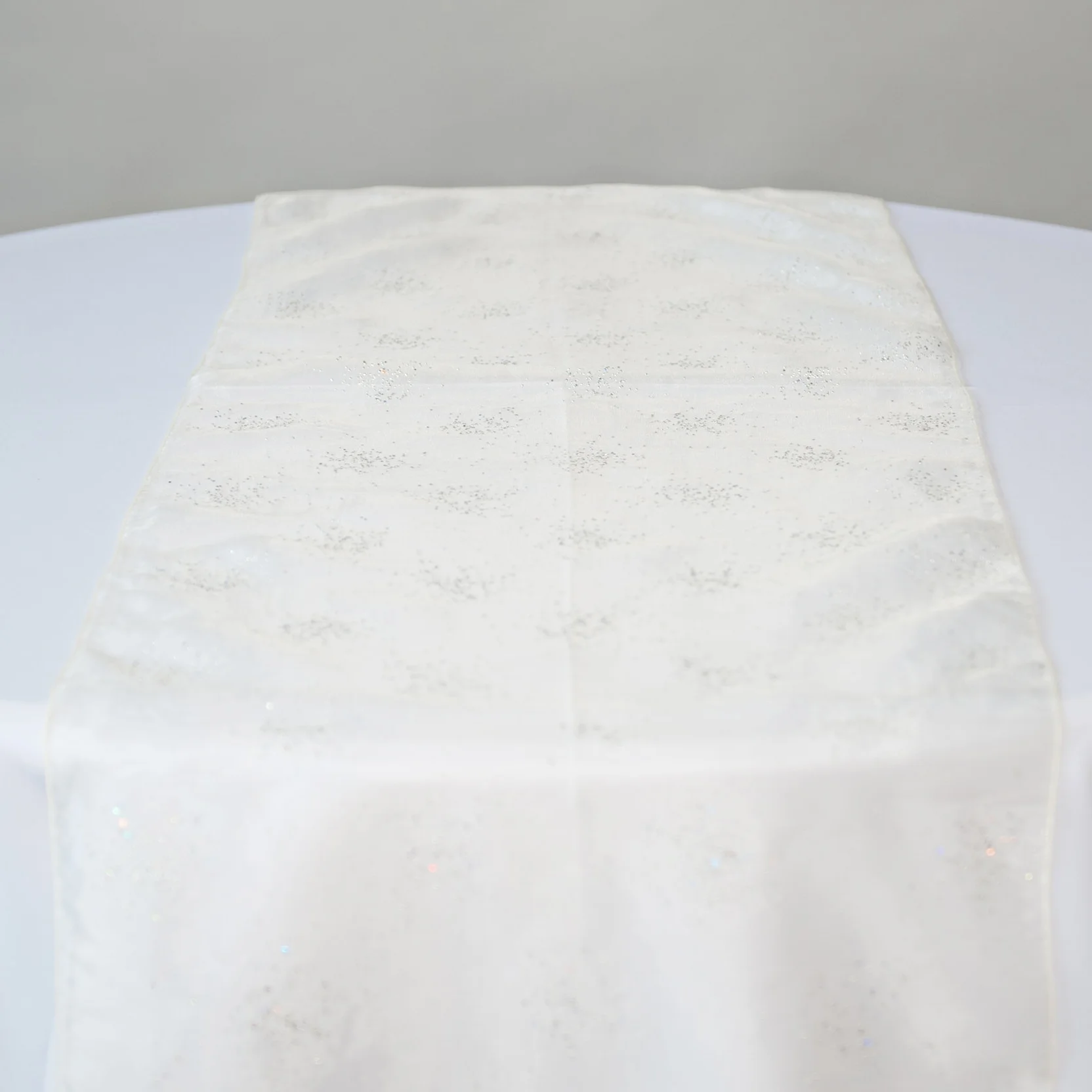 White diamond organza table runner on table