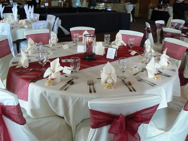 Burgundy organza table runner on table with chairs