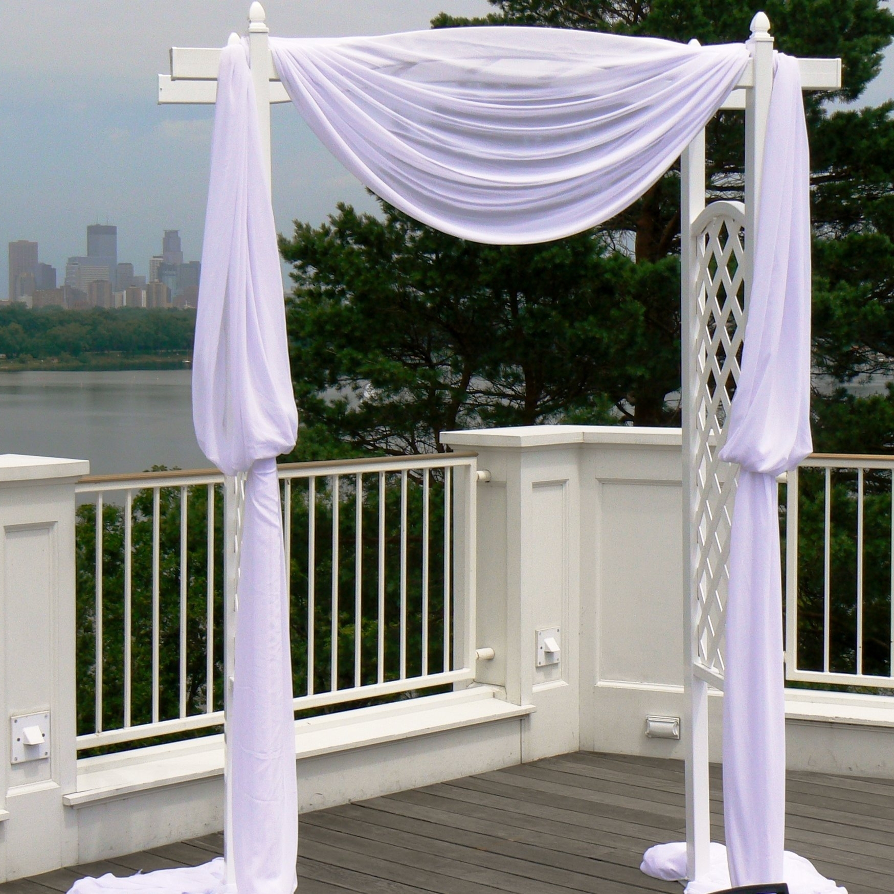 white lattice arch outdoor with added draping for a more dramatic look