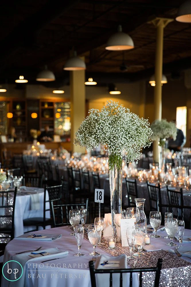 pink sequin table runner on reception table with candle and flower centerpieces