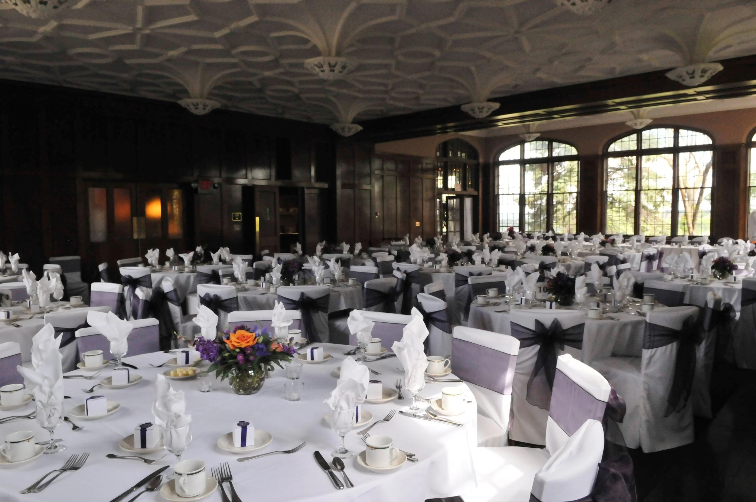 eggplant organza sashes on chairs around reception chairs