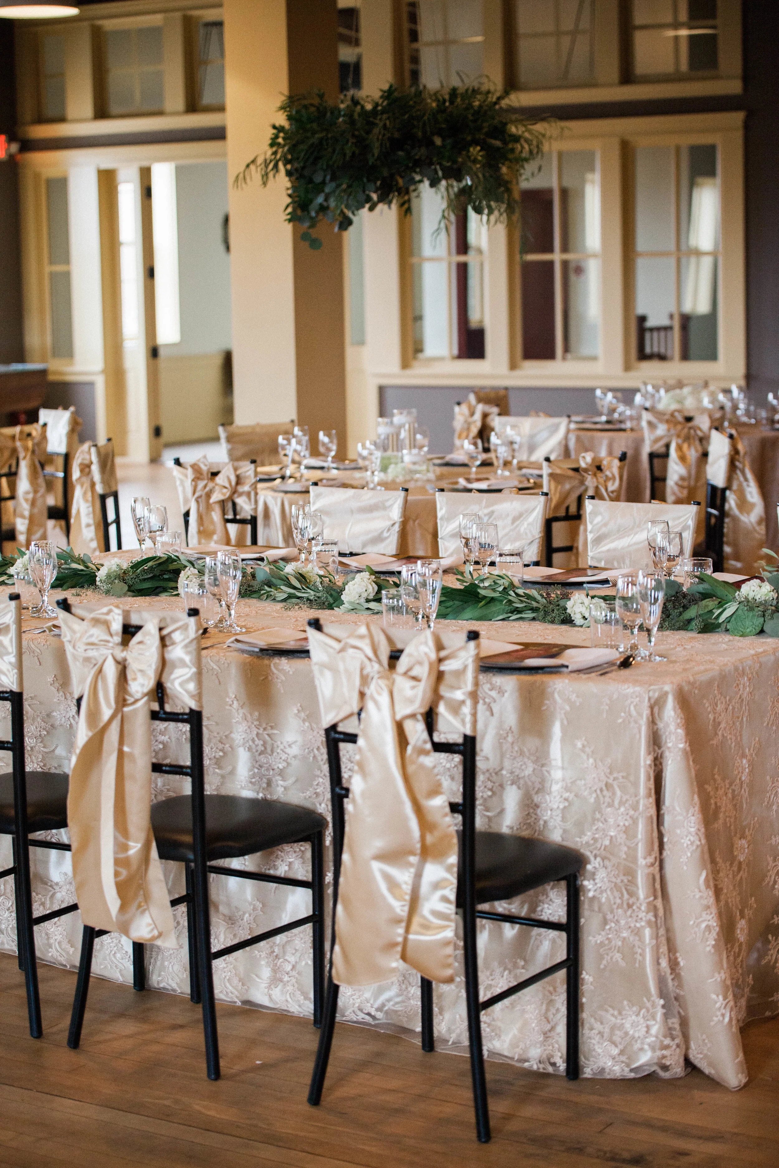 champagne satin sashes tied in bows at the head table