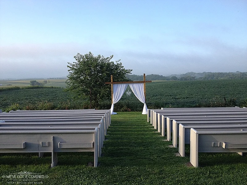 Crisp morning wedding with an outdoor ceremony that has draping on the arch and a chandelier.