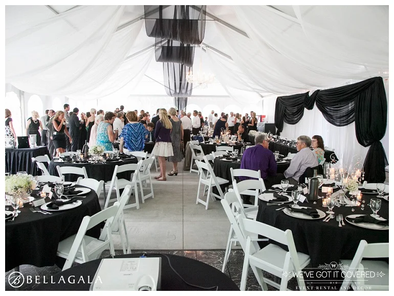 black and white classic style tent wedding with black and white draping and crystal chandeliers