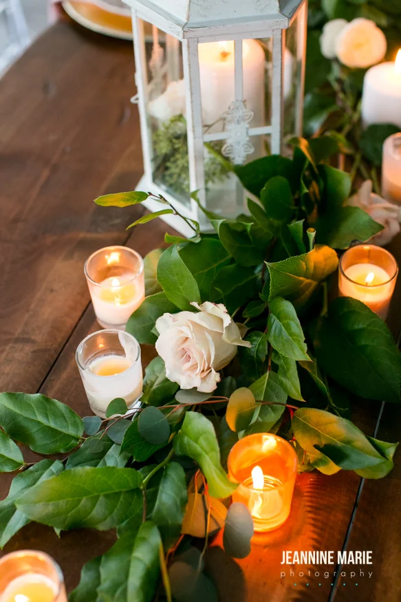 romantic candles intermixed with greenery and lantern decor