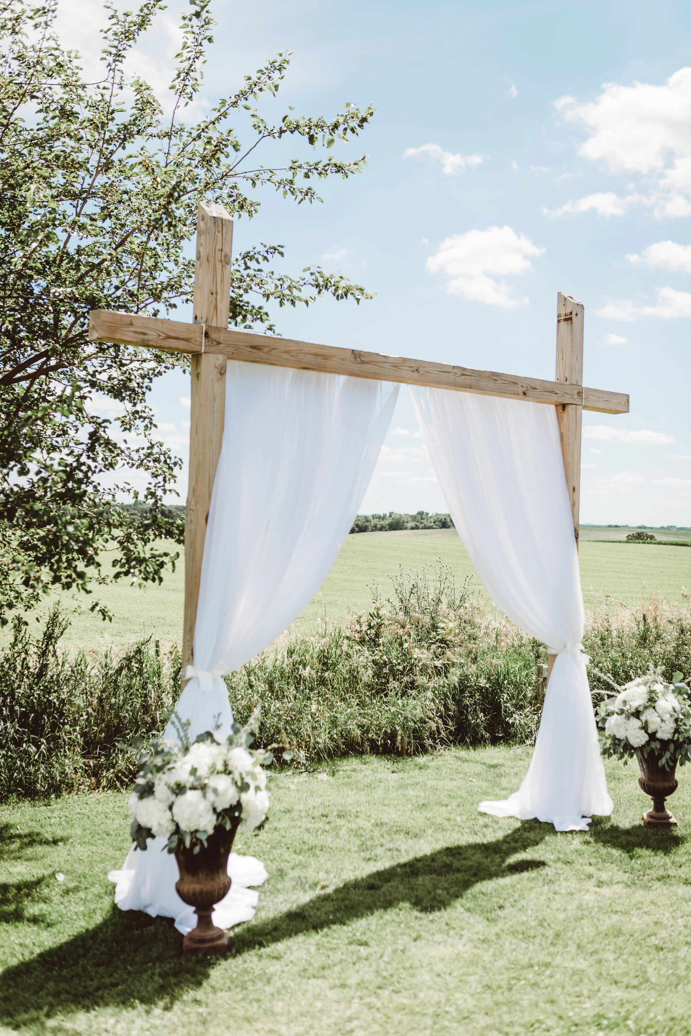 Wedding ceremony arch curtain draping outdoors
