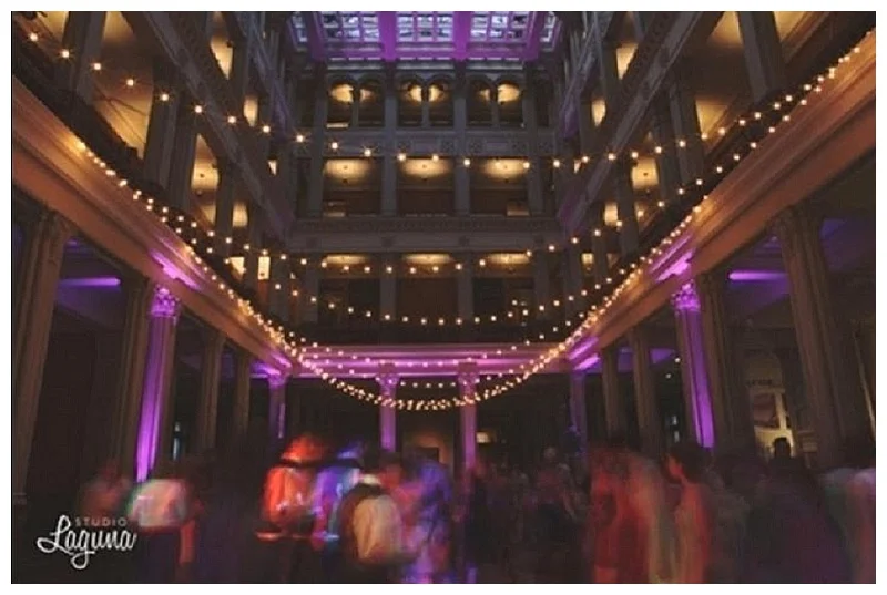 Cafe lights strung in the St.Paul Landmark Center from the second floor for a Minnesota wedding