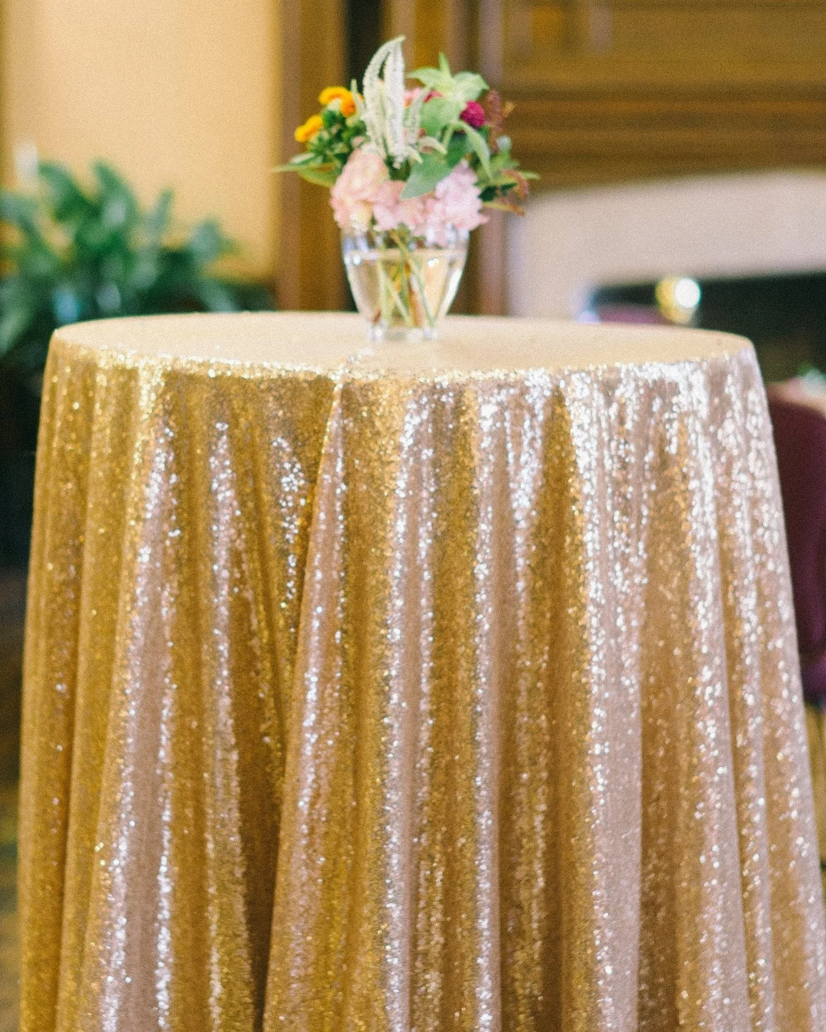 Gold sequin table linen with flowers on top