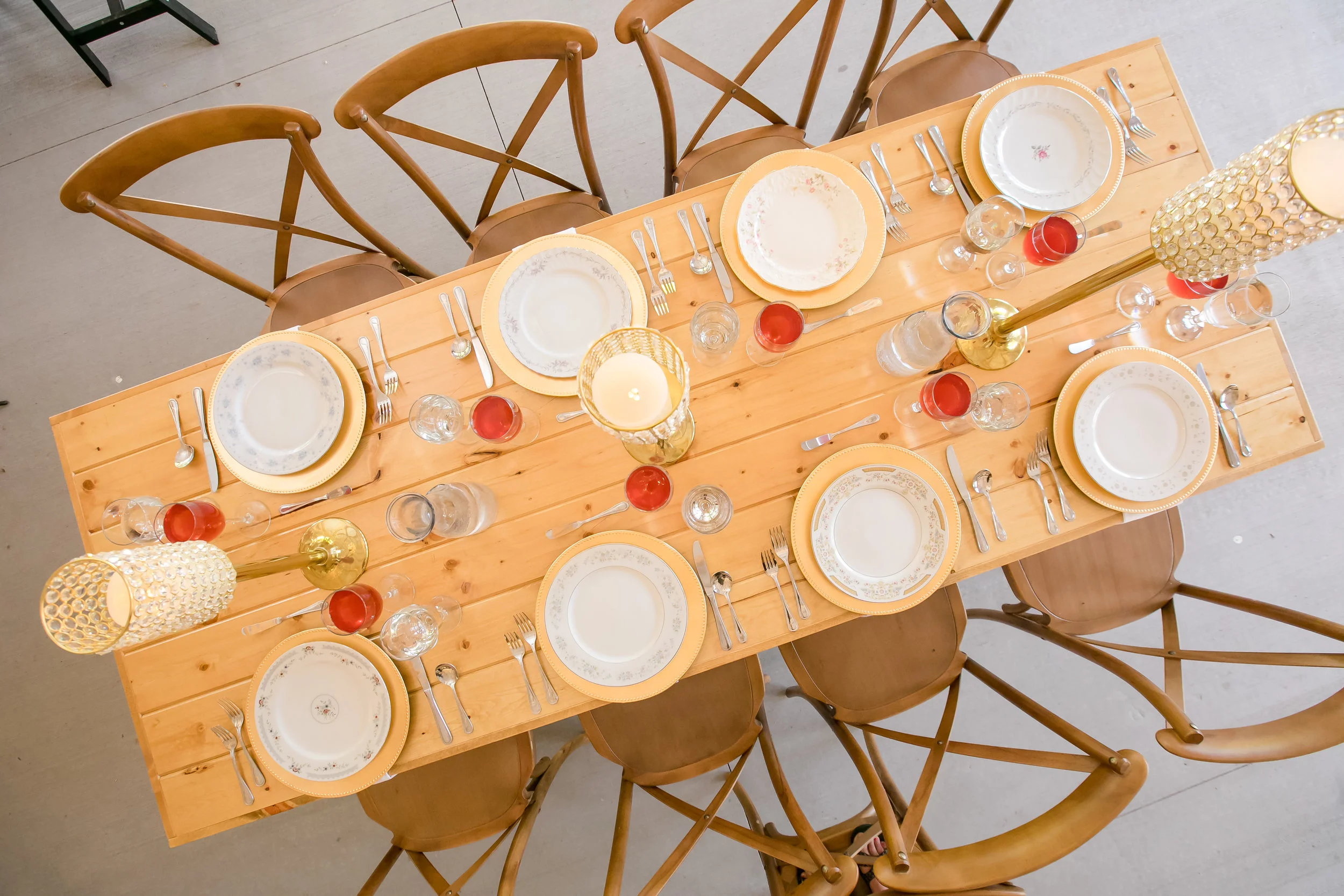 Farmstyle reception decor with gold chargers and candles
