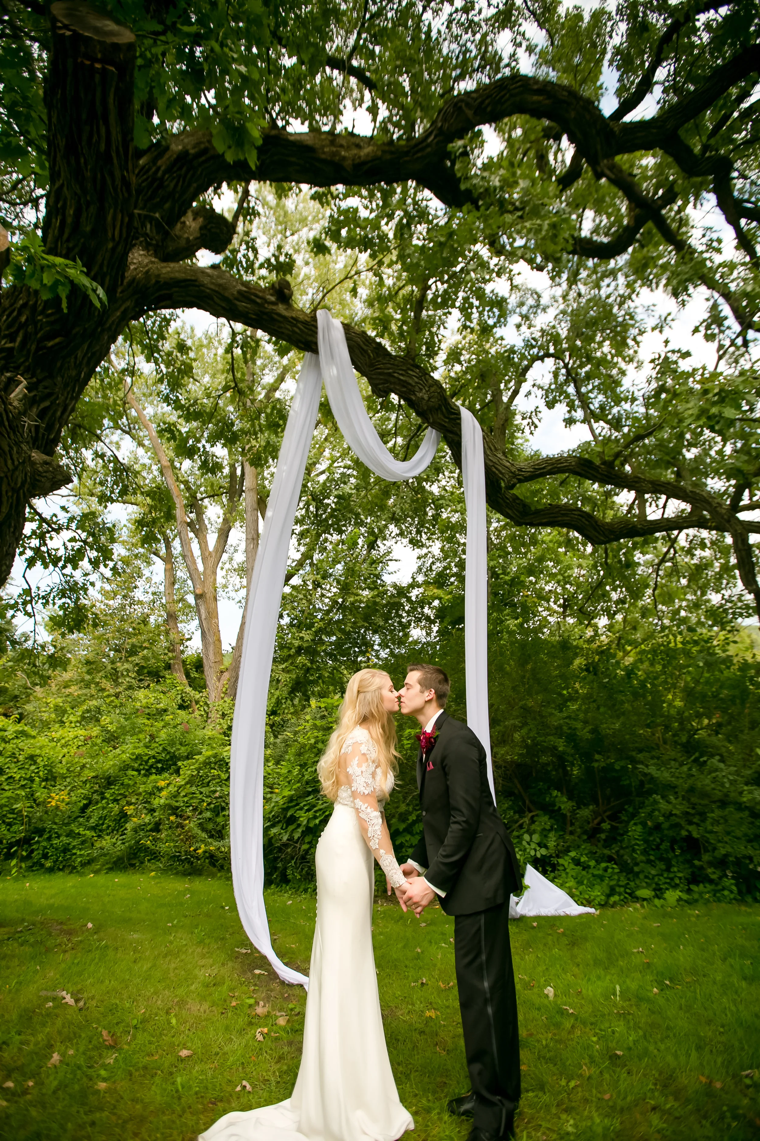 couple kissing under dreamy draping