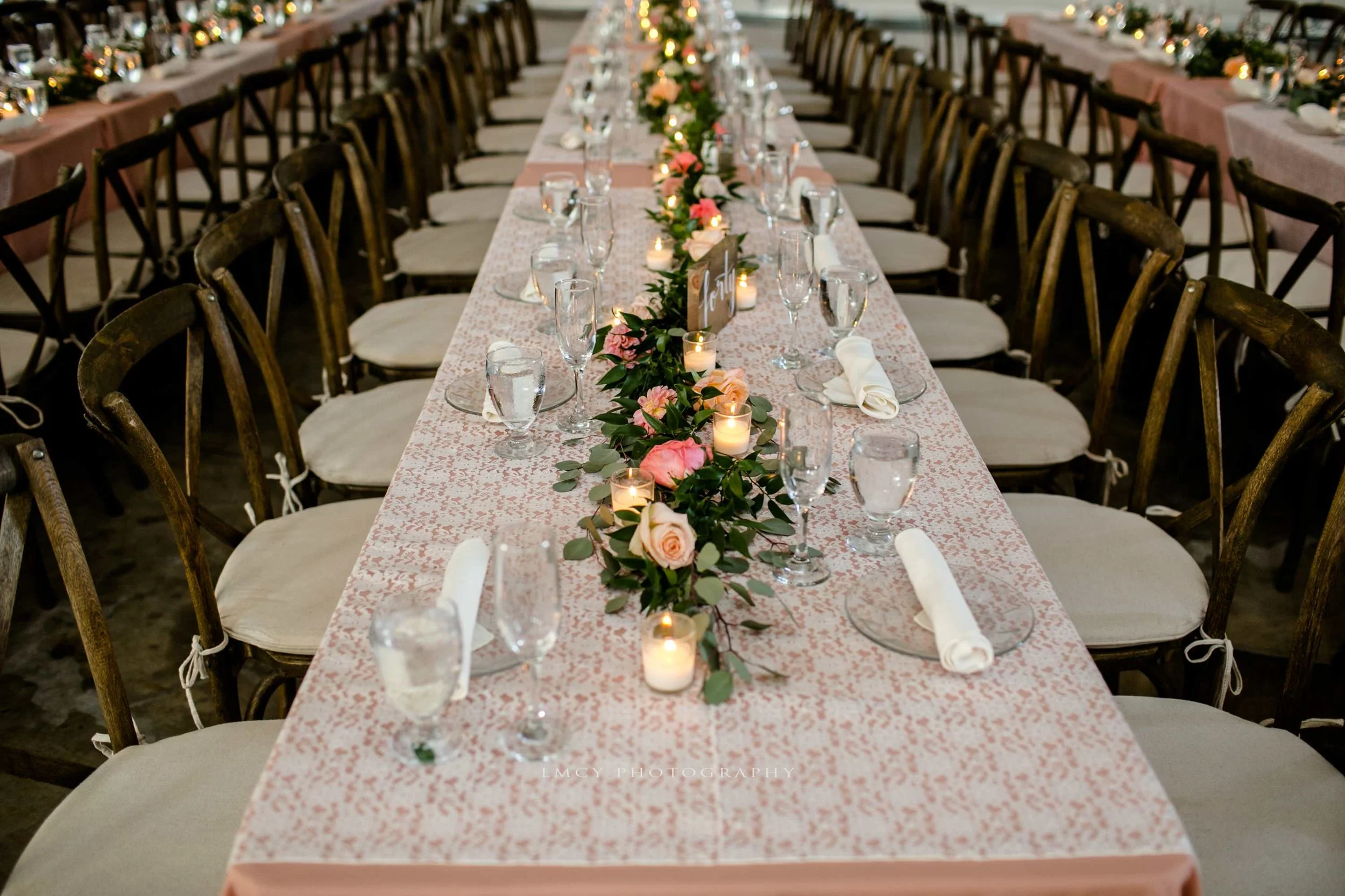 pink table linens with lace overlays and green garland centerpieces