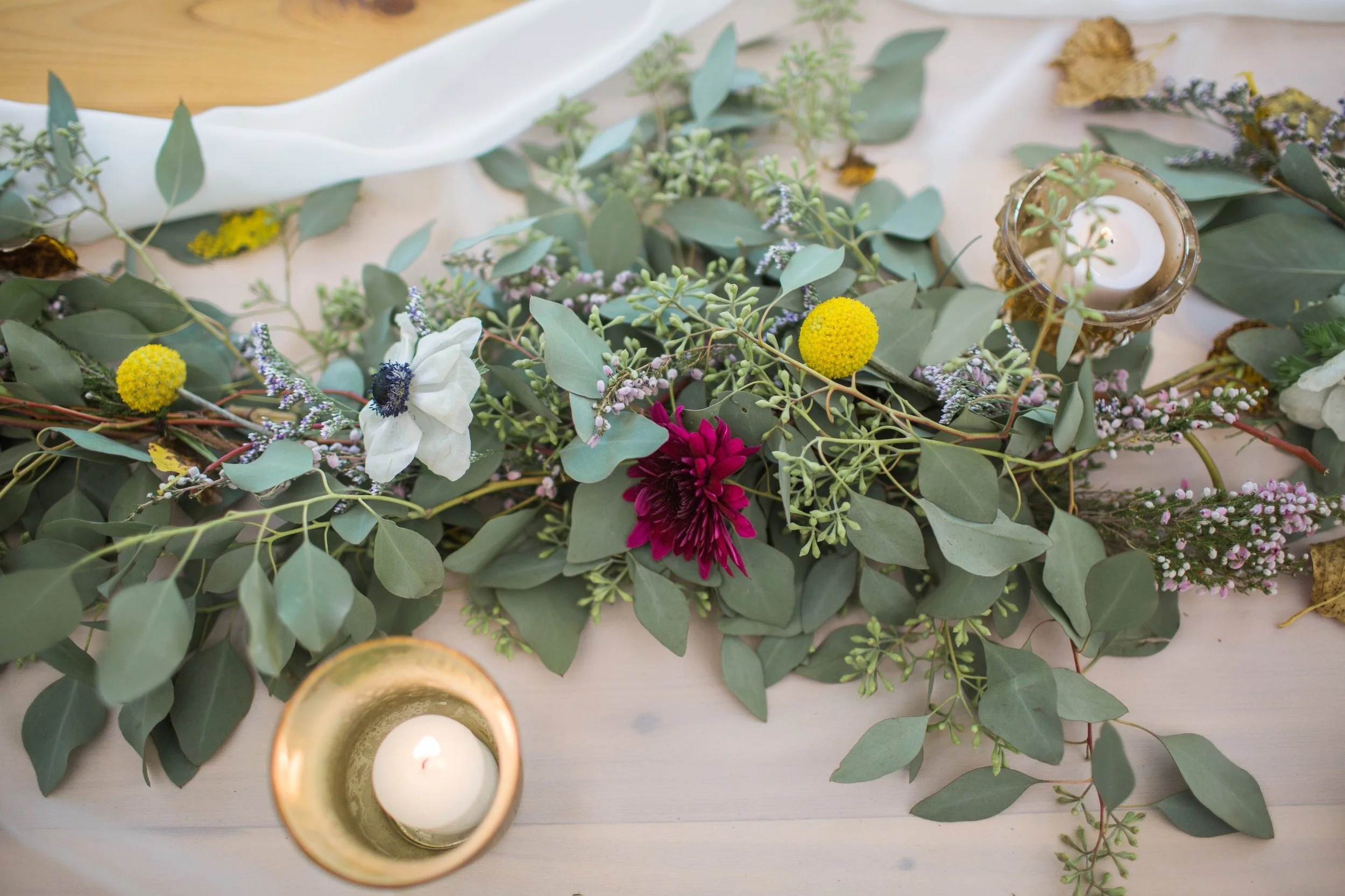chiffon runner on wood table with green garland