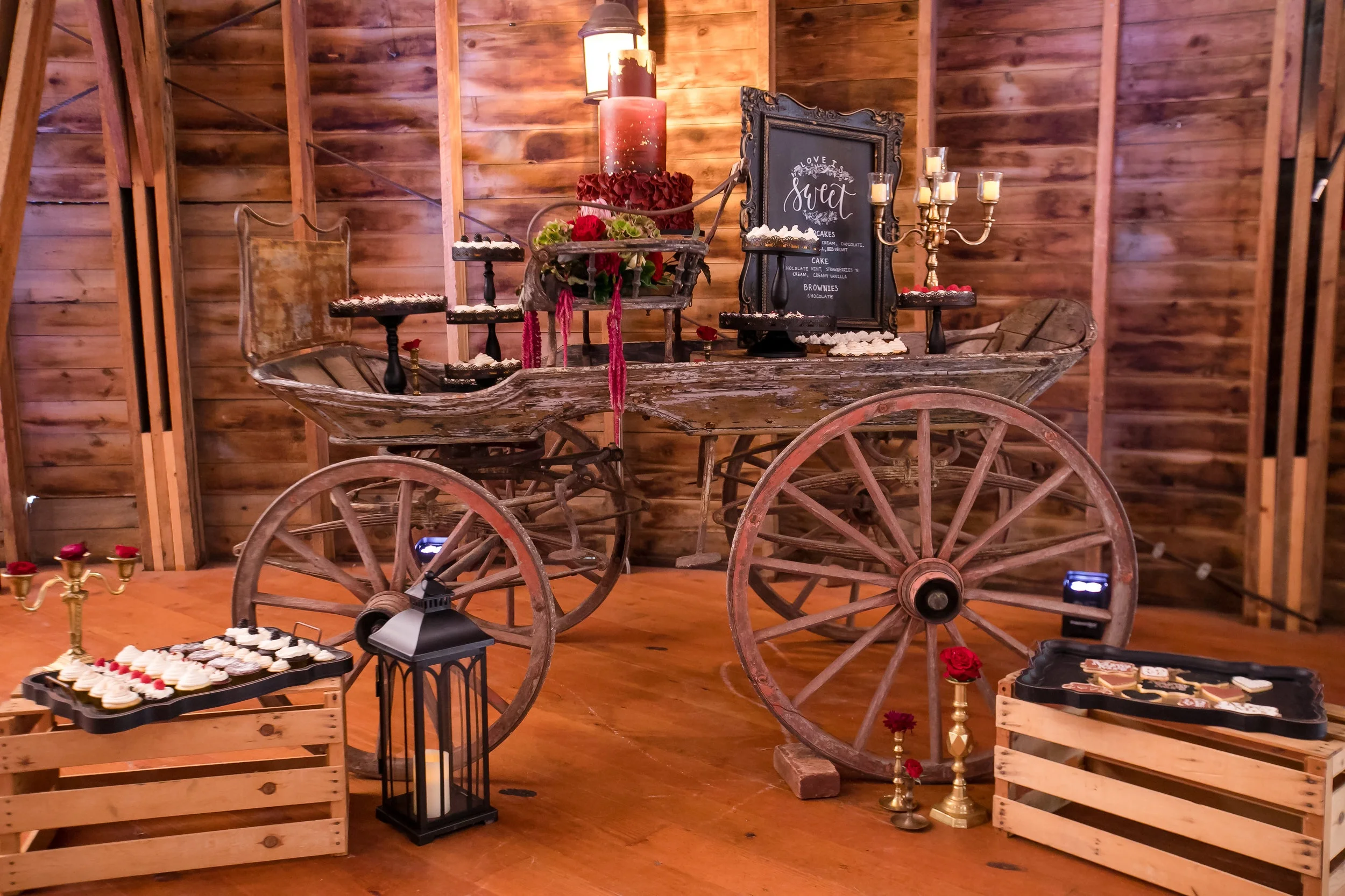 Dessert display on an old wooden cart to keep the style of the bride’s taste