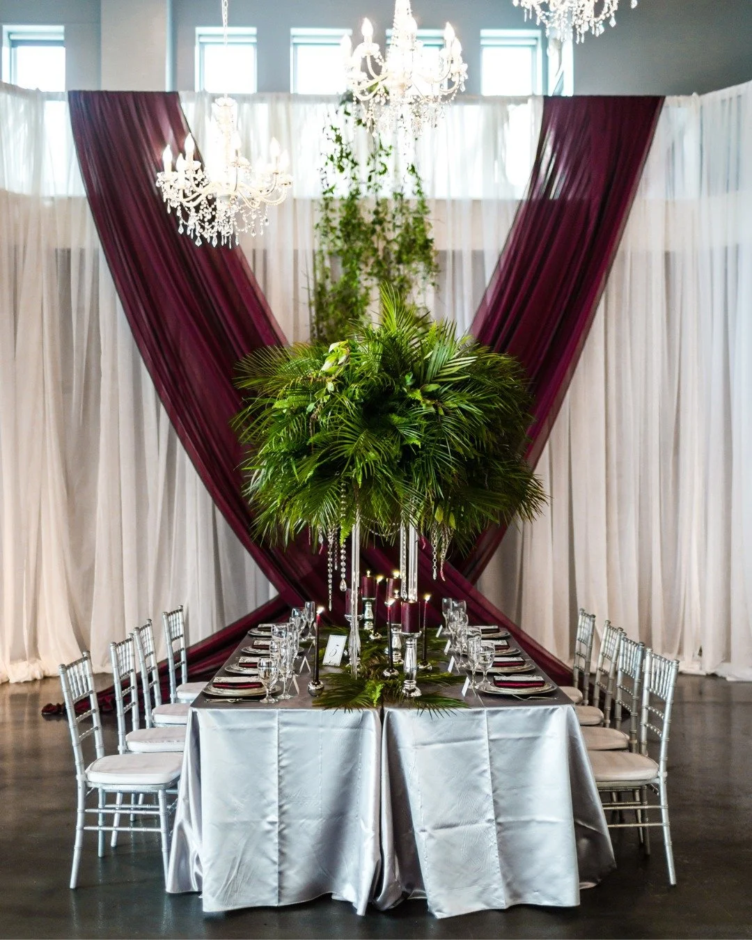 Elevating wedding attire to an art form. This incredible paper gown is the star, complemented by deep berry hues and metallic details.

#mnwedding #mnweddingvenue #ceilingdraping