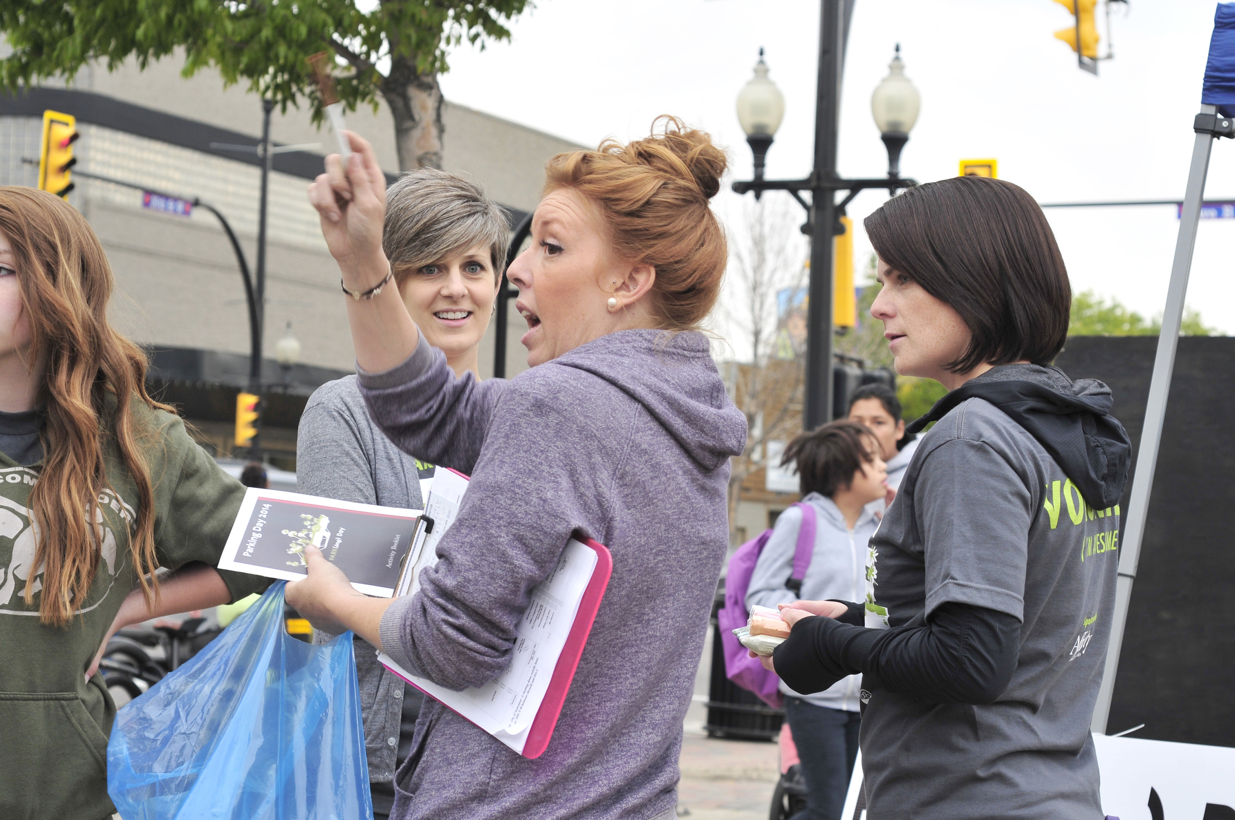 Event Manager Mandy Pravda (center) discusses logistics with Volunteer Coordinator Shannon Richards (centre-left) and crew.