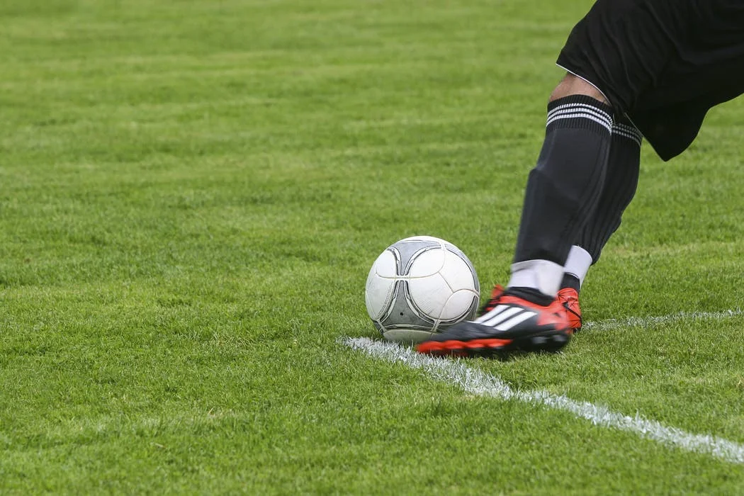 foot kicking soccer ball.jpeg