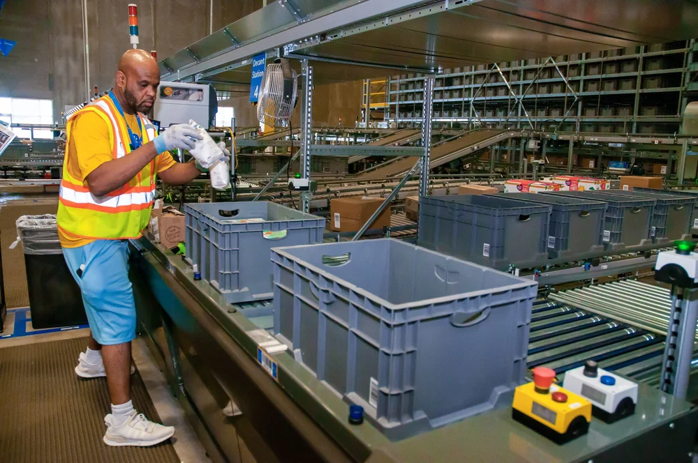 associate-decanting-merchandise-in-totes-in-a-next-generation-fulfillment-center.jpg