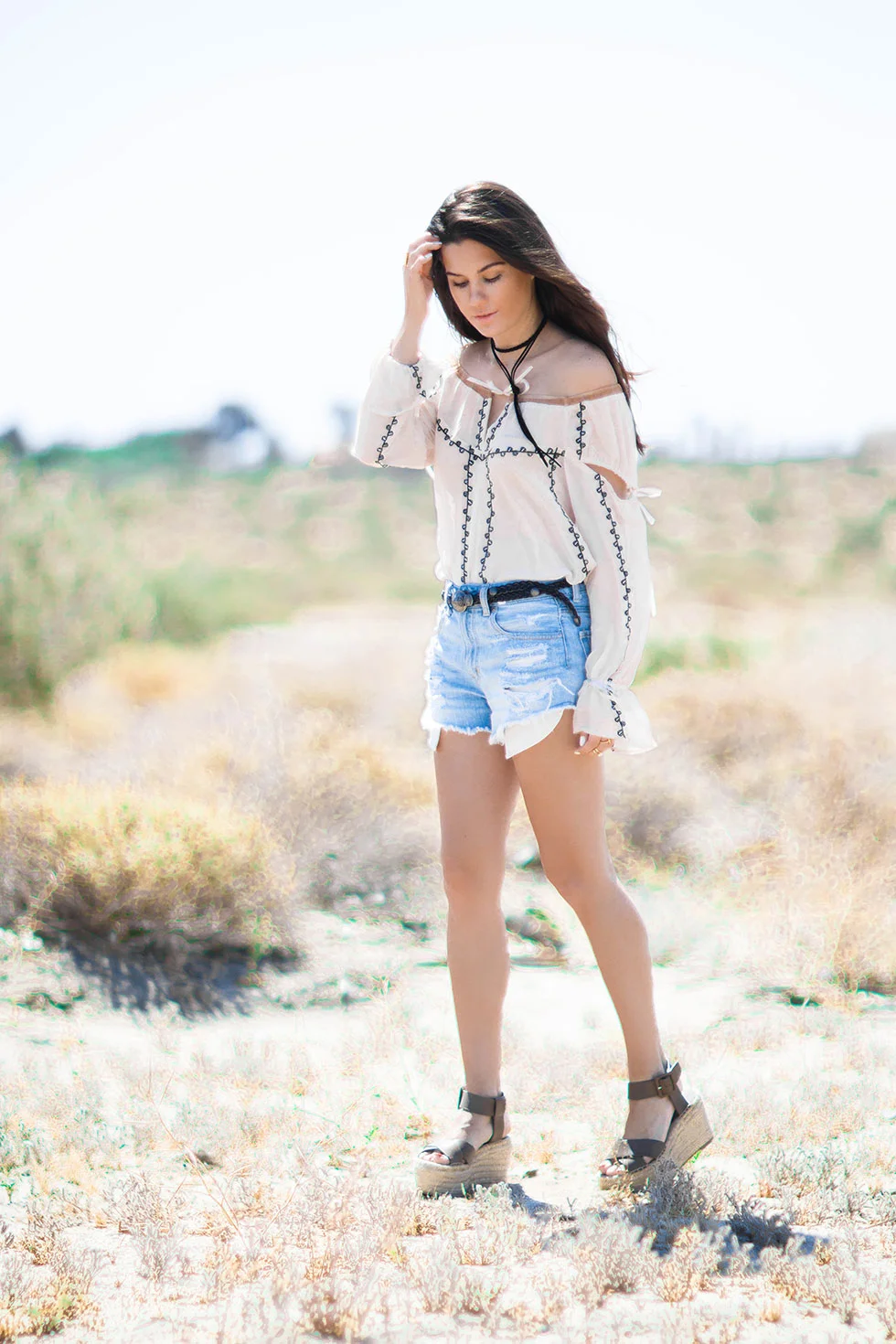 festival inspired Coachella outfit featuring a breezy For Love and Lemons Niccola Top with embroidery and tulle paneling and distressed cut off denim shorts