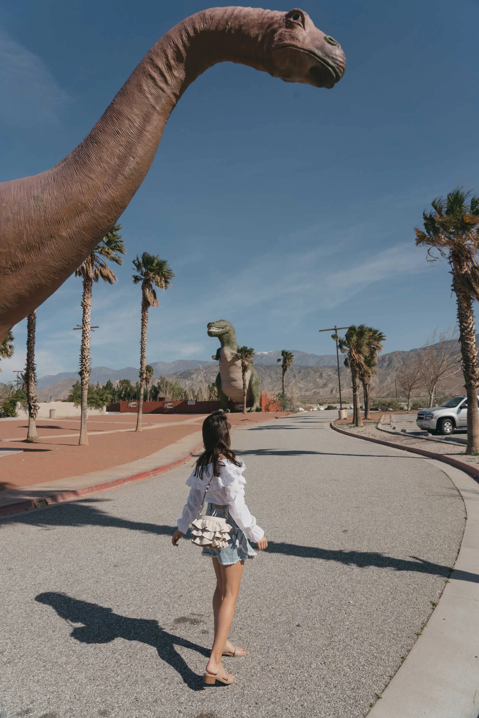 Festival-outfit-off-the-shoulder-ruffle-blouse-ruffle-denim-skirt-cabazon-dinosaurs1.jpg
