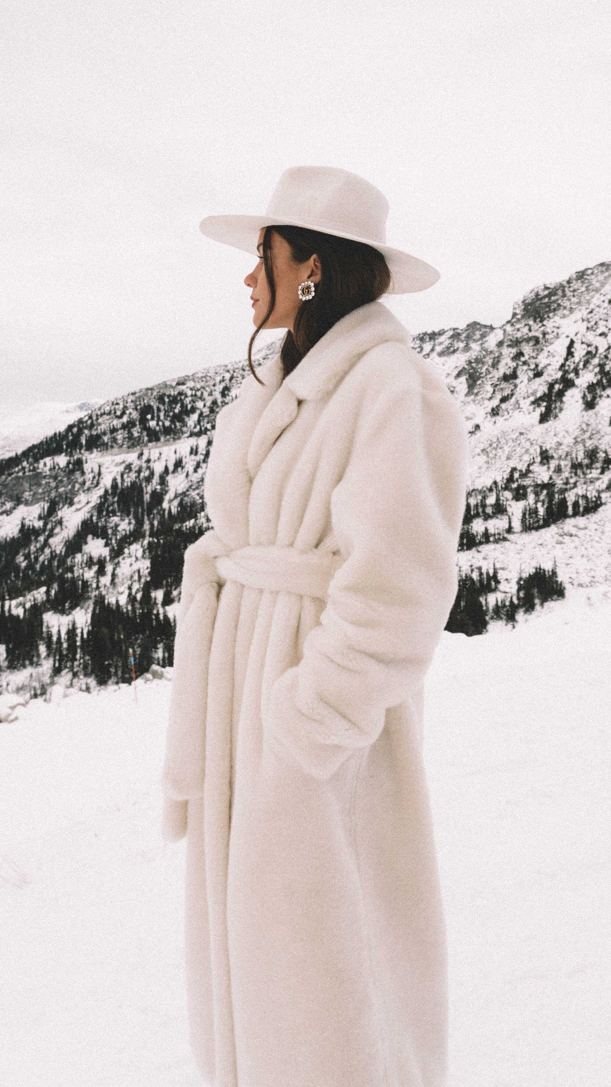 Easy-Winter-Outfit-Ideas.-Sarah-Butler-of-@sarahchristine-wearing-TIBI-Oversized-belted-faux-fur-coat,-white-hat,-and-Gucci-Crystal-Double-G-earrings-in-Whistler,-Canada--7.jpg