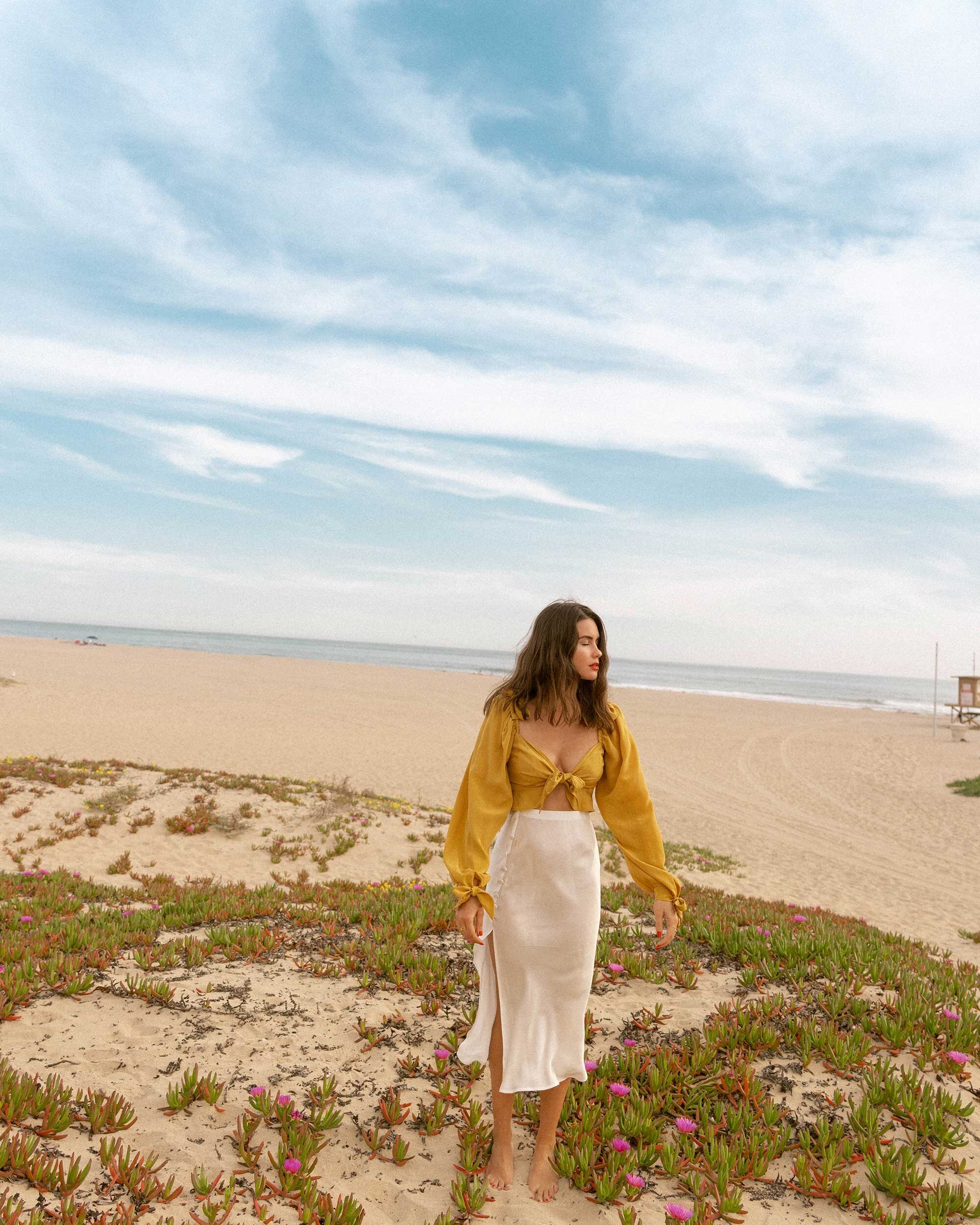 Click+to+shop+outfit+++more+photos!+Sarah+Butler+of+Sarah+Styles+Seattle+wears+Yellow+bell+sleeve+crop+top+and+side+slit+silk+midi+skirt+in+Newport+Beach,+California+for+the+perfect+summer+outfit+|+@sarahchristine+-1.jpg