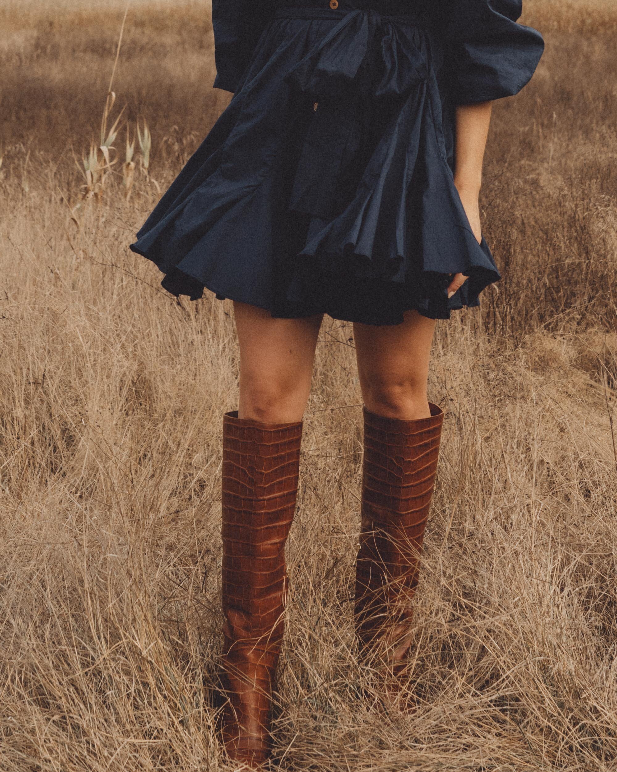 Chic Fall Dress Outfit. Sarah Butler of @sarahchristine wearing Rhode Emma Tie-Waist Flared Navy Dress and Brown Croc Knee High Boot in Seattle, Washington --7.jpg