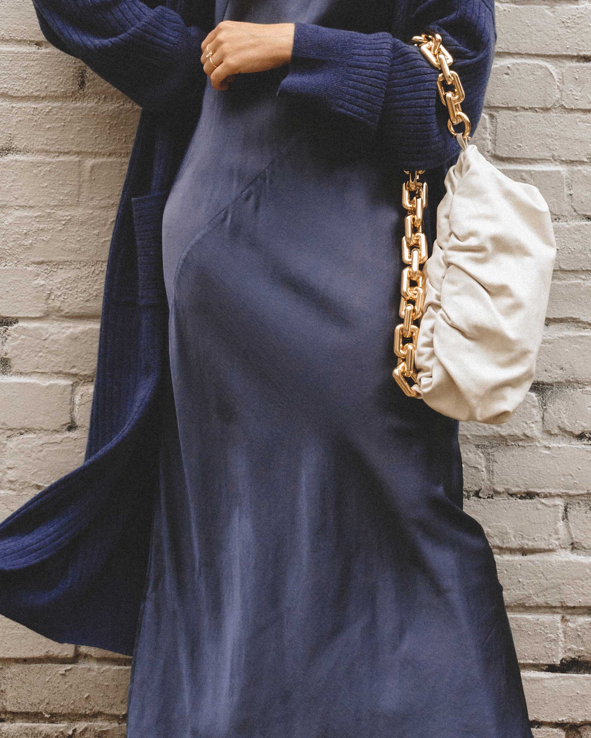 How to style a dress for winter. Sarah Butler of @sarahchristine wearing Line and Dot navy silk satin dress, Sablyn Long Cashmere Sweater, and Bottega Veneta The Chain Pouch Leather Clutch in Seattle, Washington -2.jpg