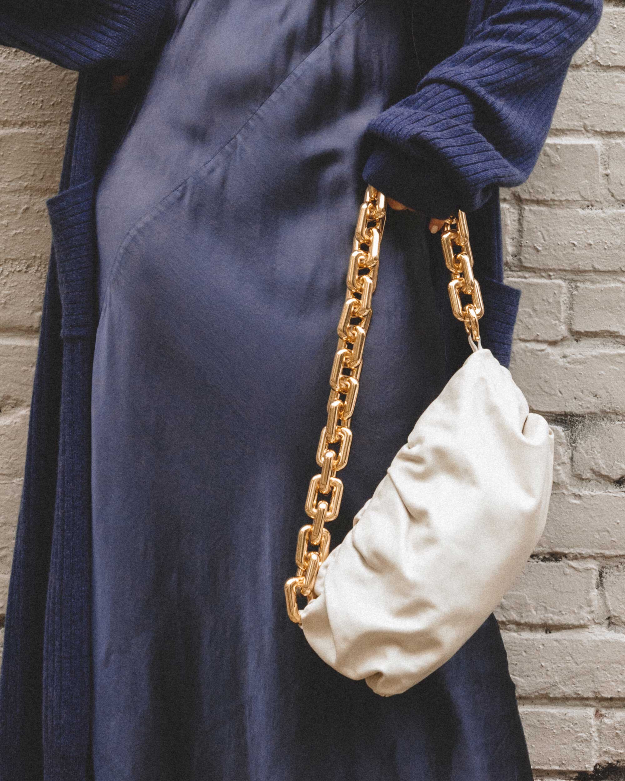 How to style a dress for winter. Sarah Butler of @sarahchristine wearing Line and Dot navy silk satin dress, Sablyn Long Cashmere Sweater, and Bottega Veneta The Chain Pouch Leather Clutch in Seattle, Washington -1.jpg