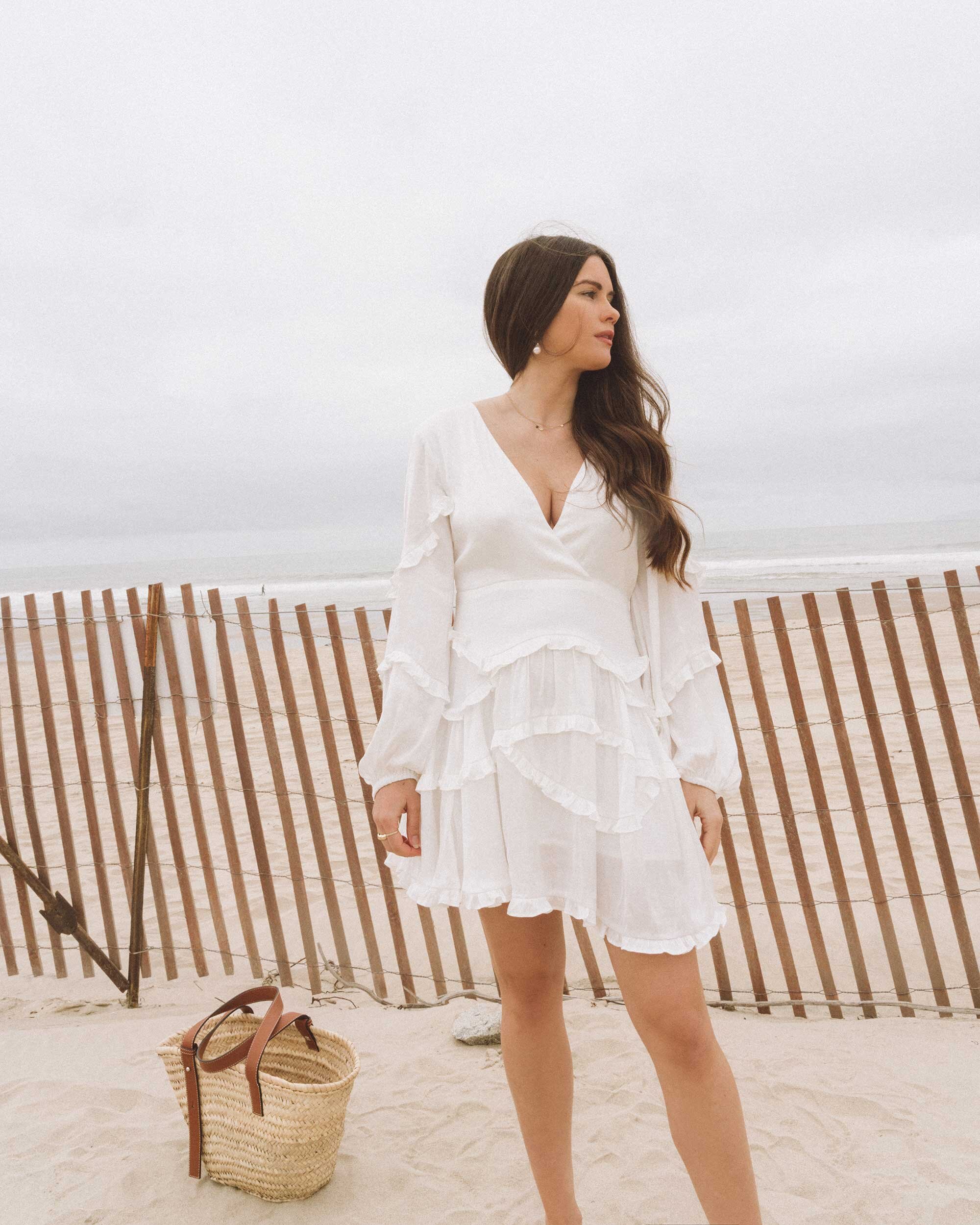 Chic white dresses for spring. Sarah Butler of @sarahchristine wearing  Charmeuse Ruffle Mini Dress with Back Tie and Flutter Sleeve Stretch Satin Dress with Ruffle Hem in Newport Beach, California -1.jpg