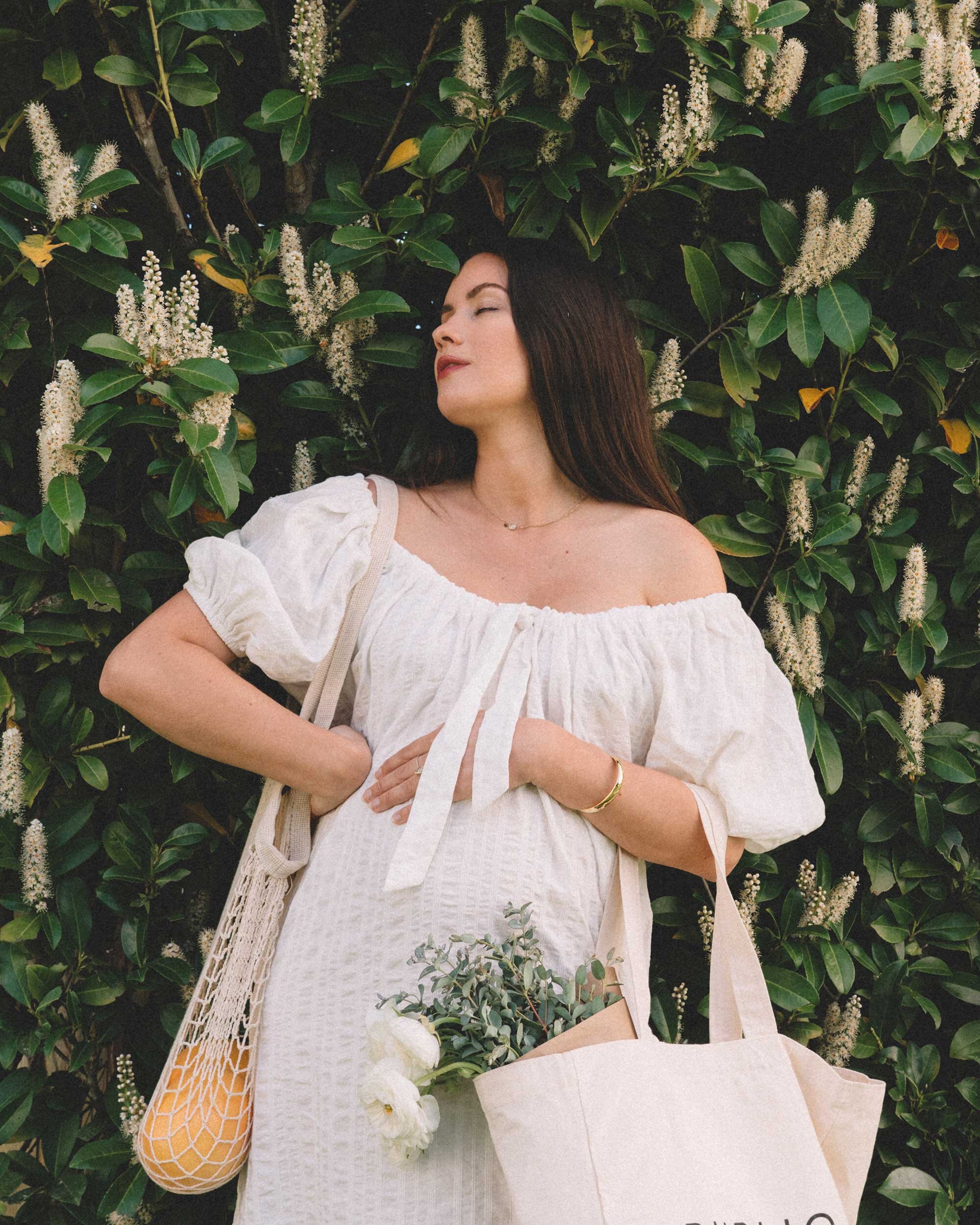 Spring Maternity Outfit Idea: white off the shoulder midi dress. Sarah Butler of @sarahchristine wearing Free People off the shoulder puff sleeve scoop neck midi dress - 1.jpg